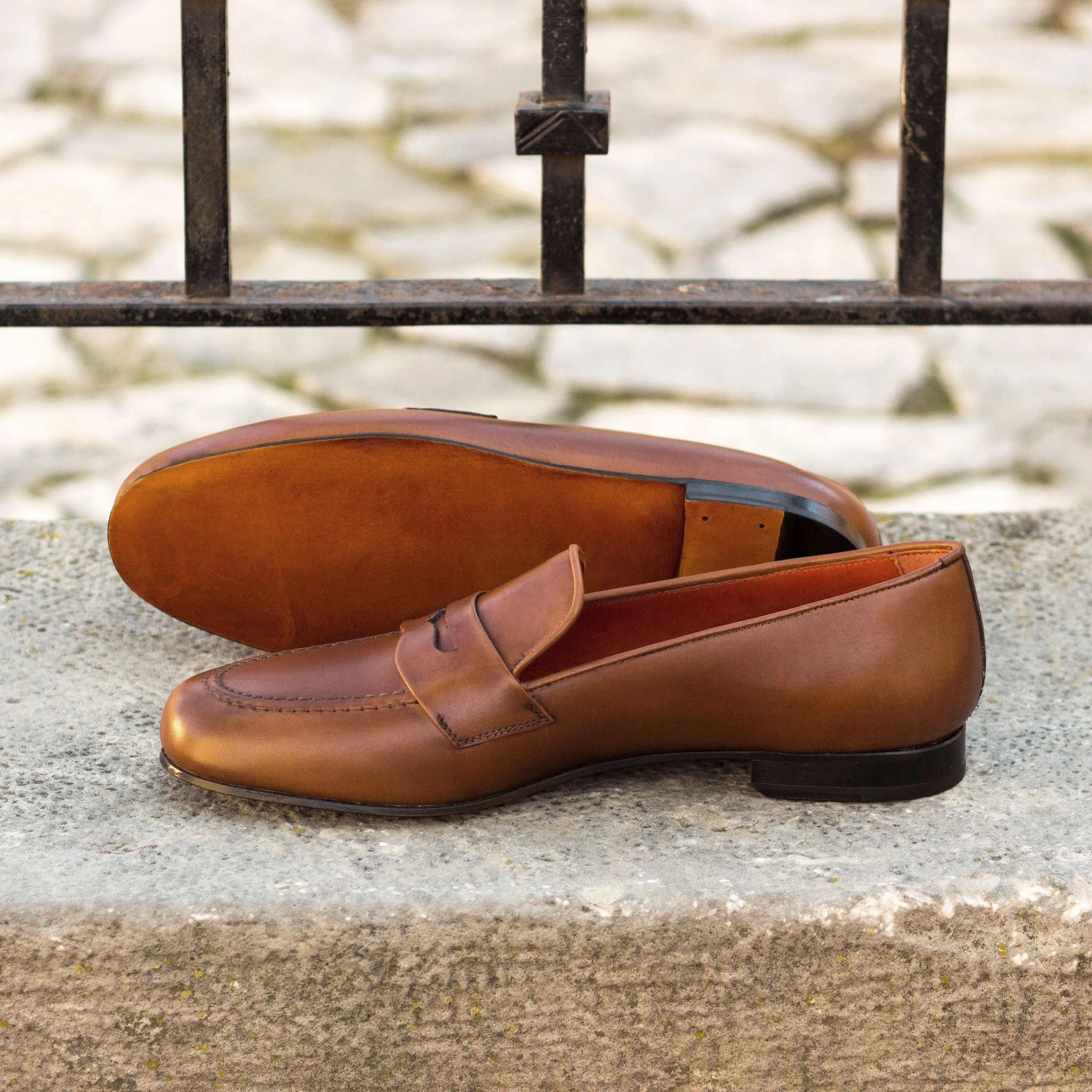 Brown leather penny loafers from Monaco Wellington slipon collection display elegance