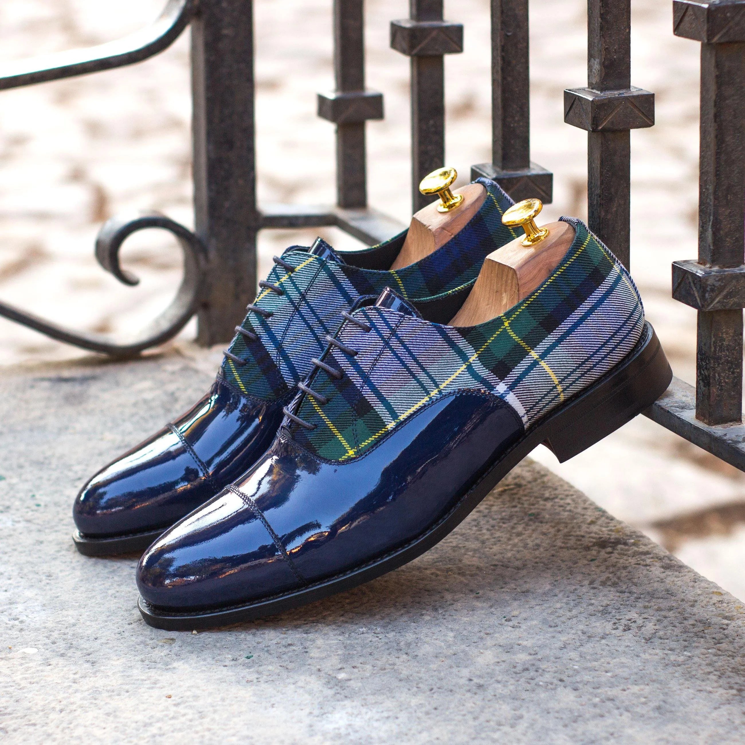 Patent leather and plaid Monty Oxford shoes displayed elegantly for formal occasions