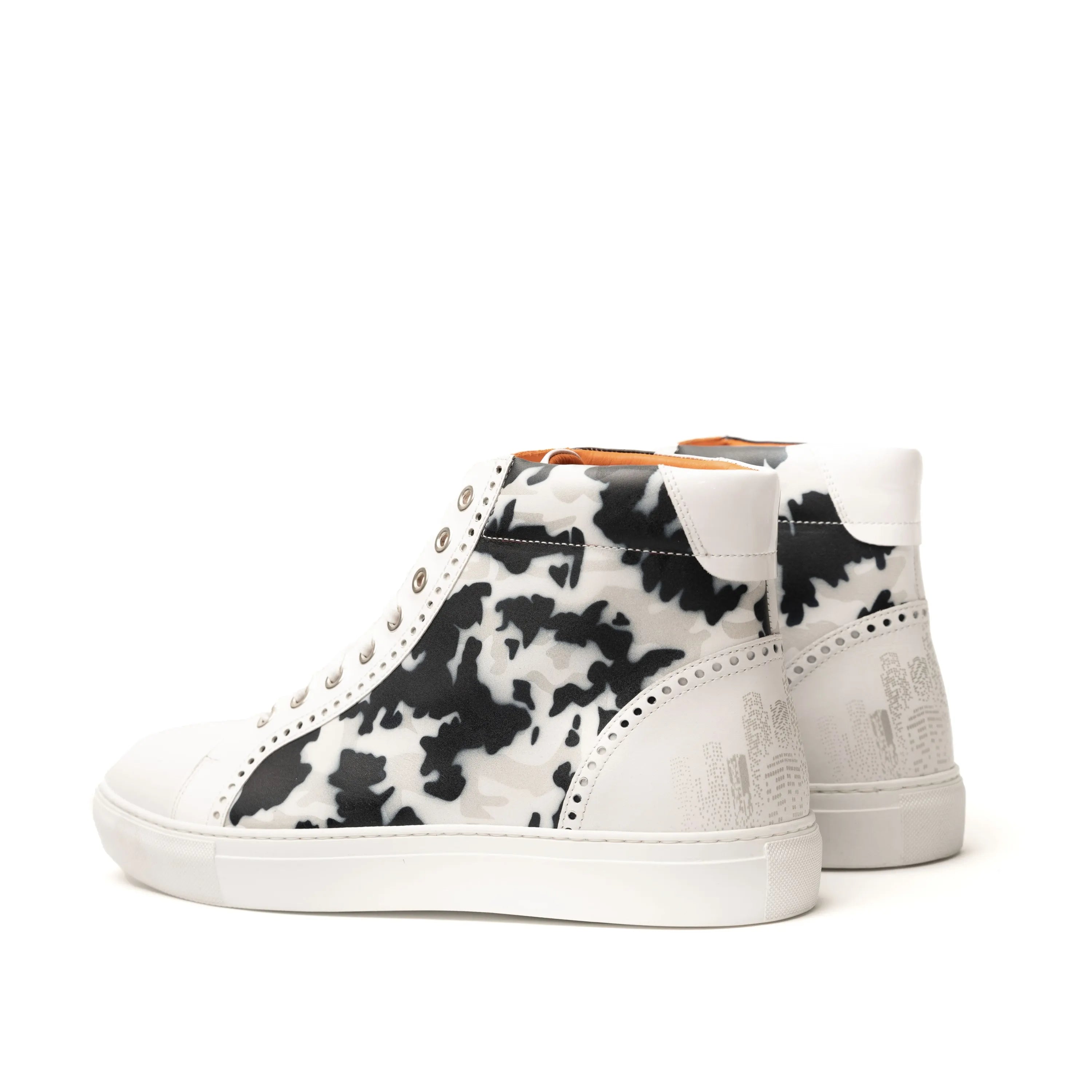 White high-top chunky trainer sneakers with black cow print, NYC High Kicks collection