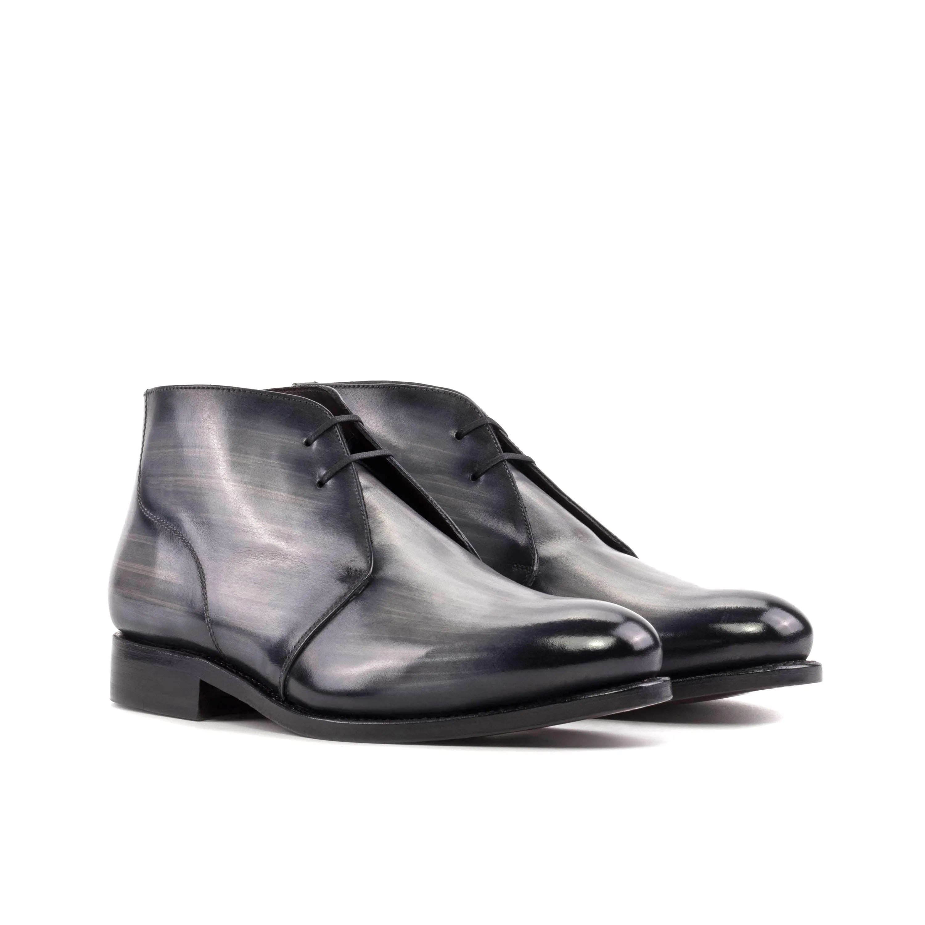 Pair of gray leather Othello Patina Chukka boots showcasing elegant design and craftsmanship