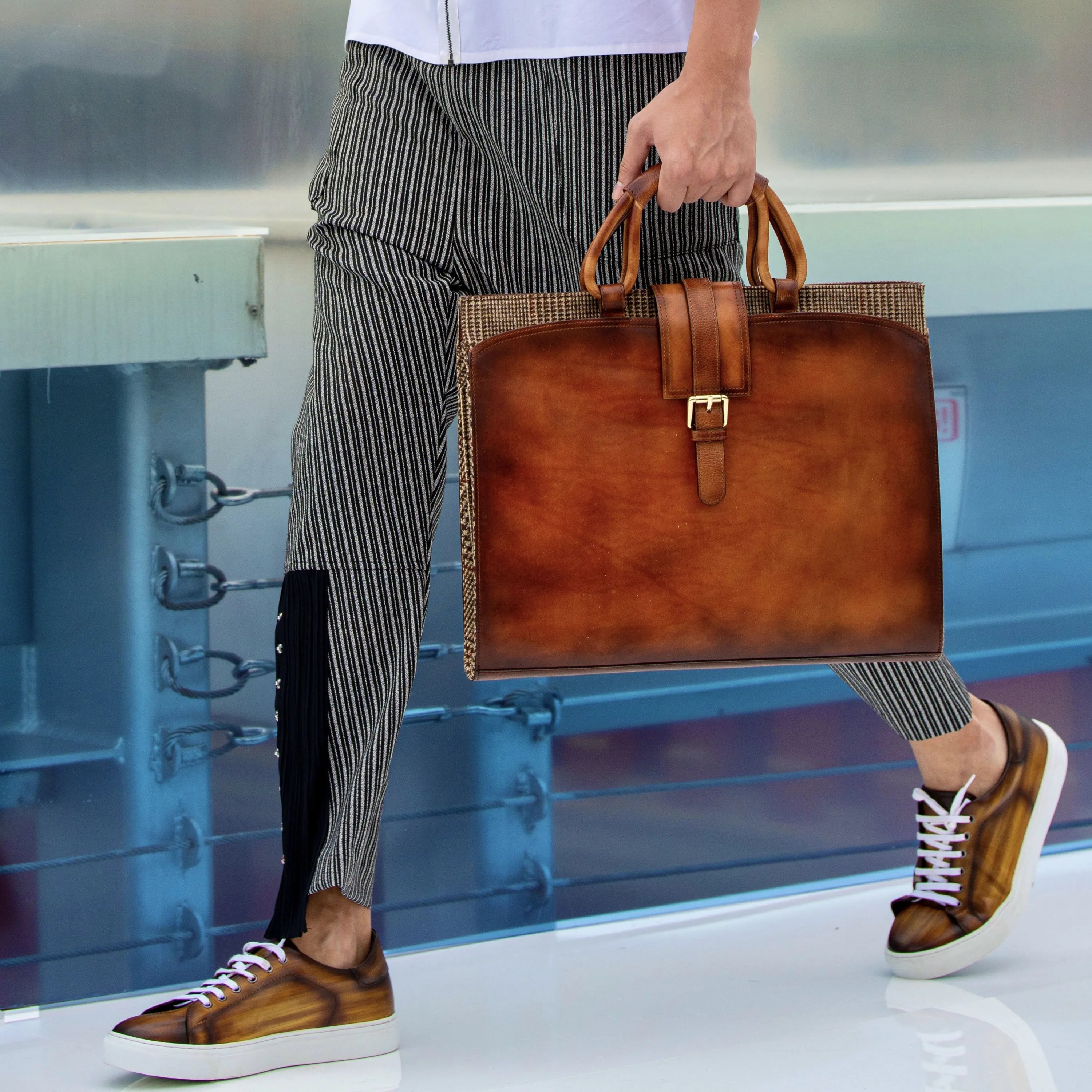Brown leather briefcase with buckle paired with Passby Trainer Patina Sneaker