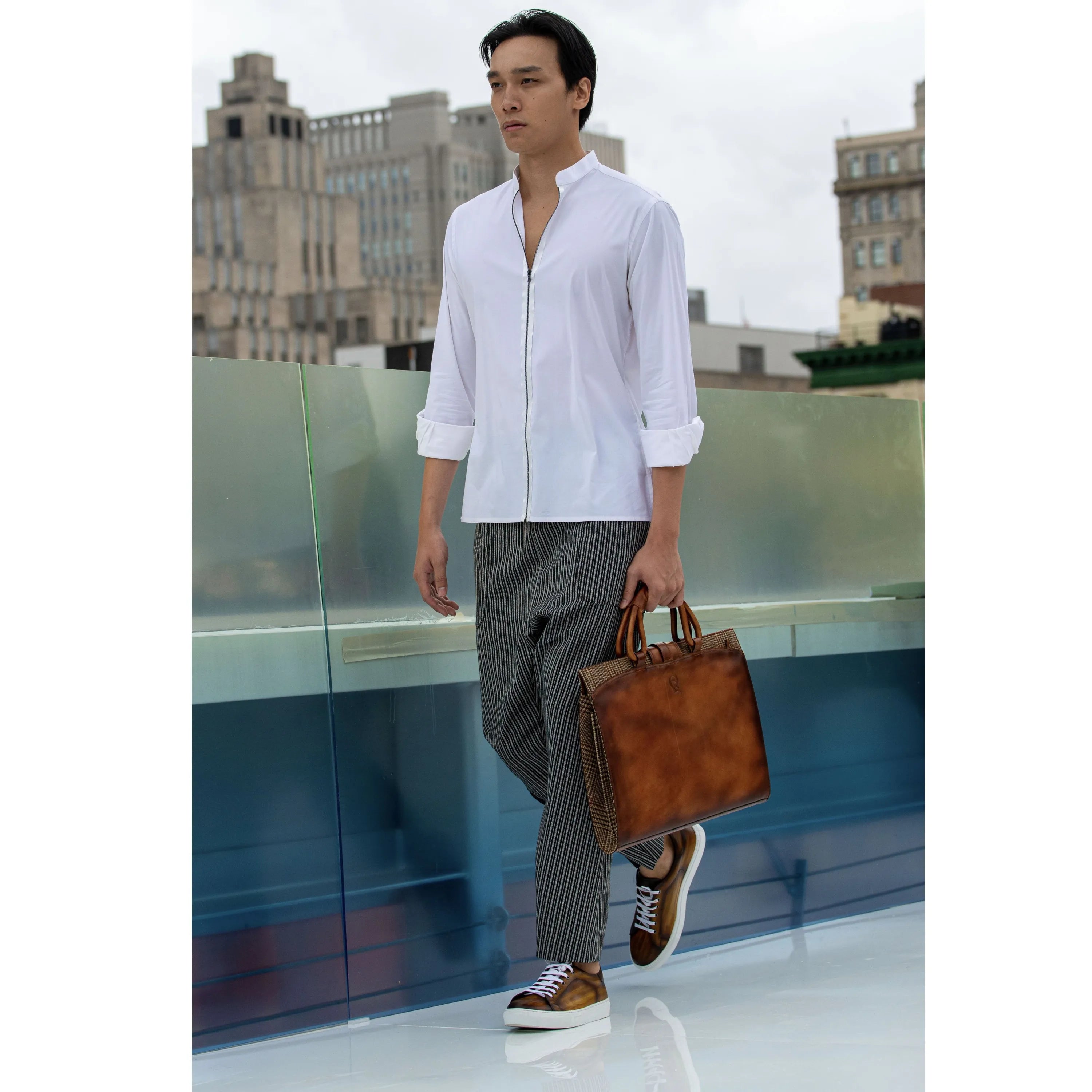 Man in stylish casual attire showcasing the Passby Trainer Patina Sneaker