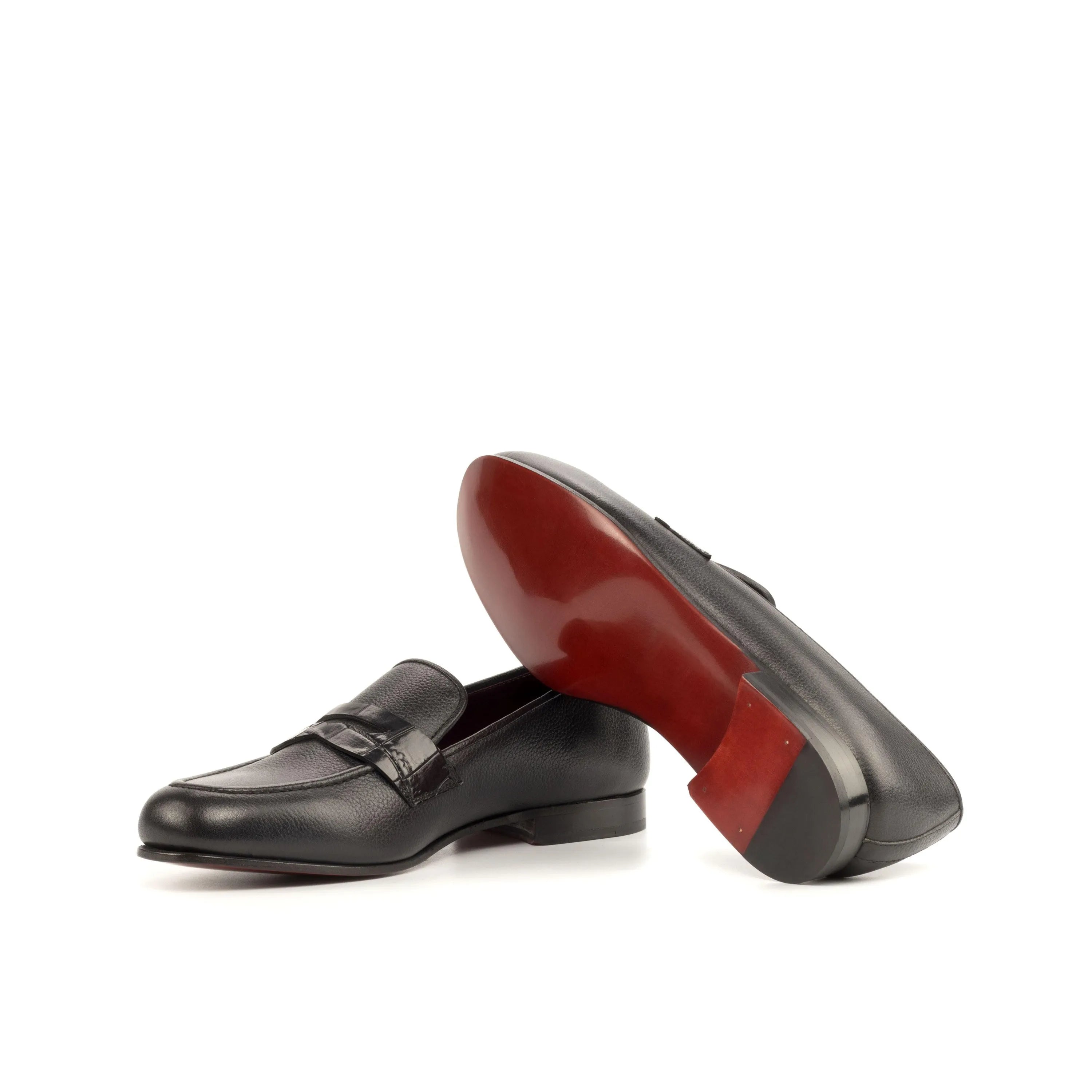 Black leather loafers with red soles, featuring Patron Wellington Slip design