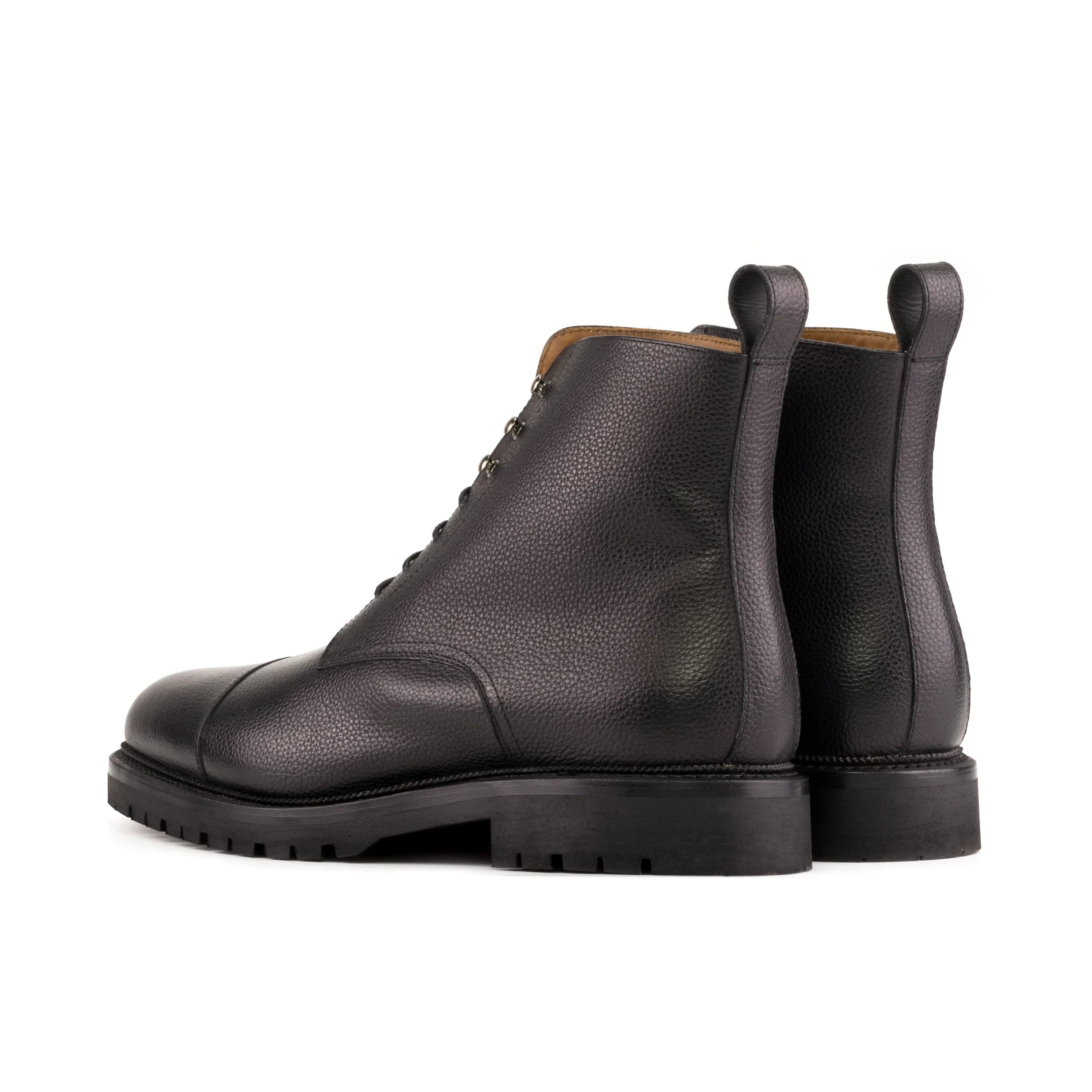 Black leather cap-toe boots showcased as Primus Jumper Boots in elegant design