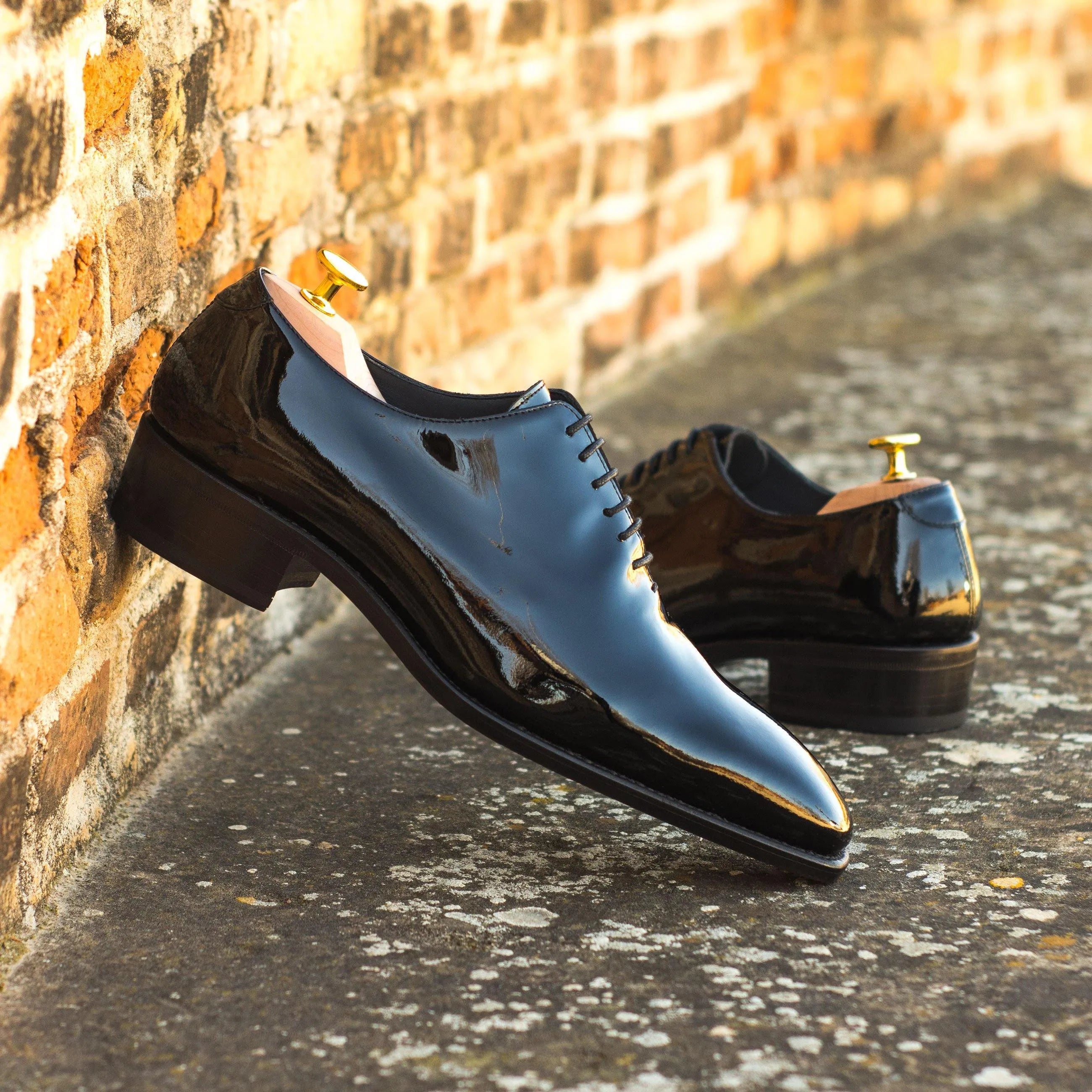 Shiny black Proper Wholecut shoes showcasing elegant craftsmanship and style