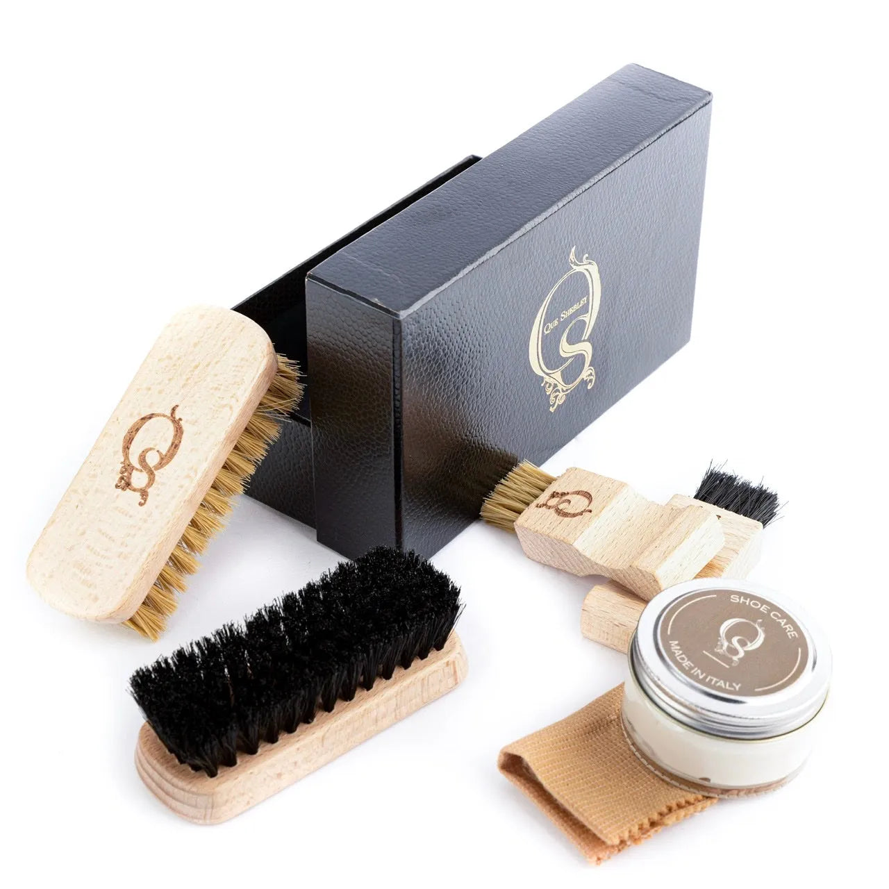 Shoe care kit featuring brushes, polish, and cloth from Q Lux Leather Care Kit II