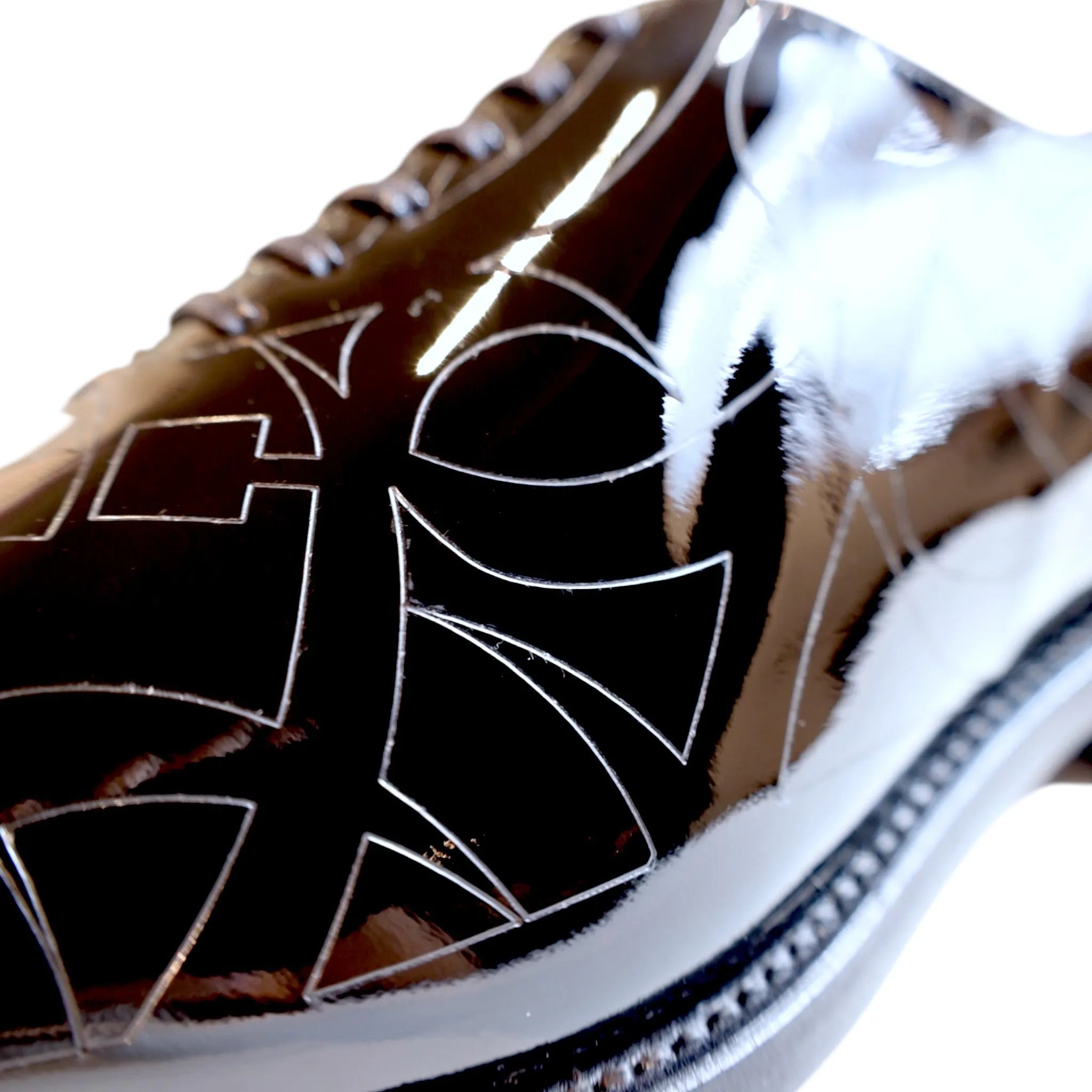 Shiny black Quswa Noir Wholecut Shoes featuring a modern geometric design