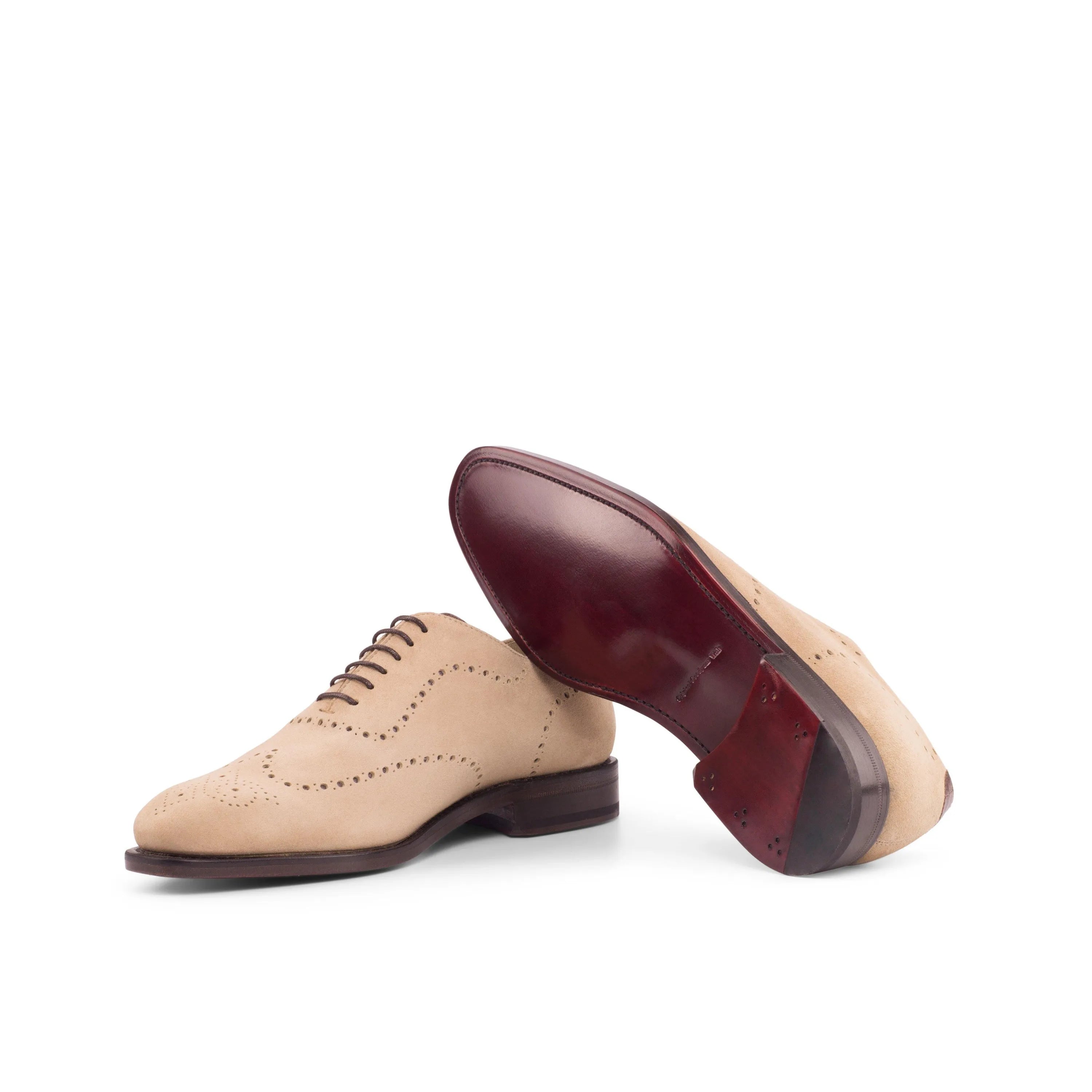 Beige leather wingtip dress shoes from the Remod Wholecut collection for luxury bespoke shoes