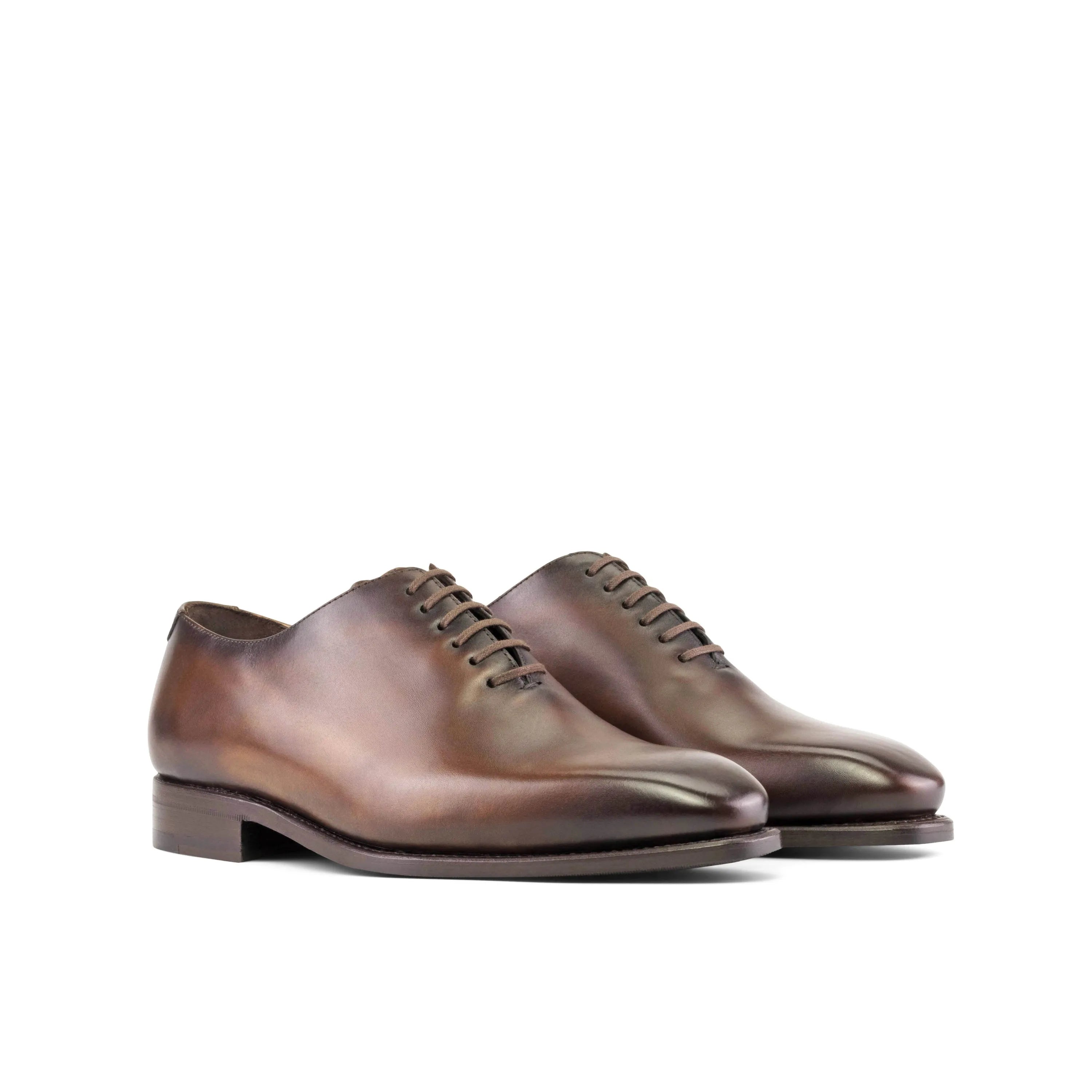 Pair of brown leather Renzo Wholecut shoes, showcasing classic elegance and style