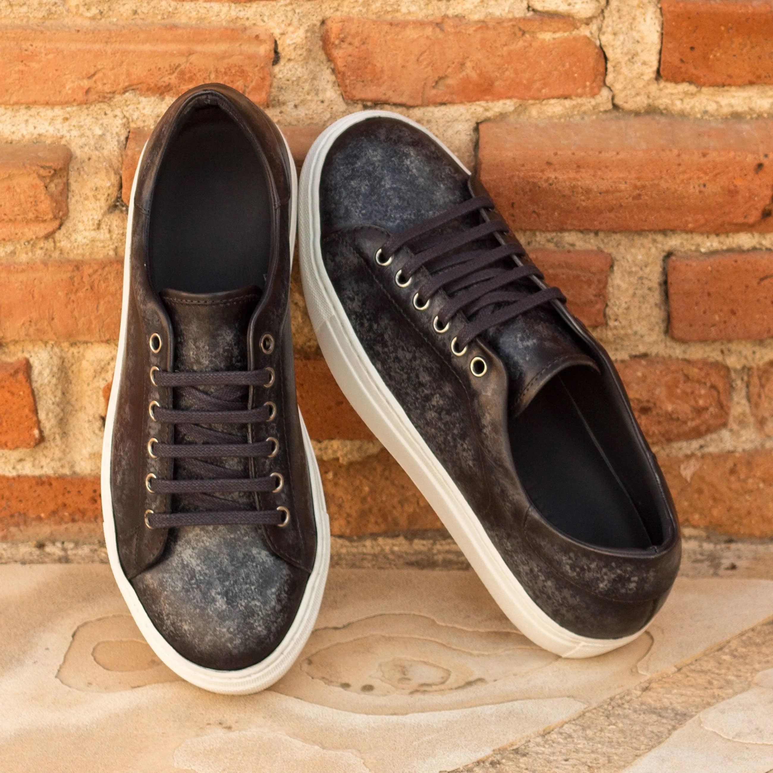Pair of black leather Sancho Trainer Patina sneakers with cupsole design