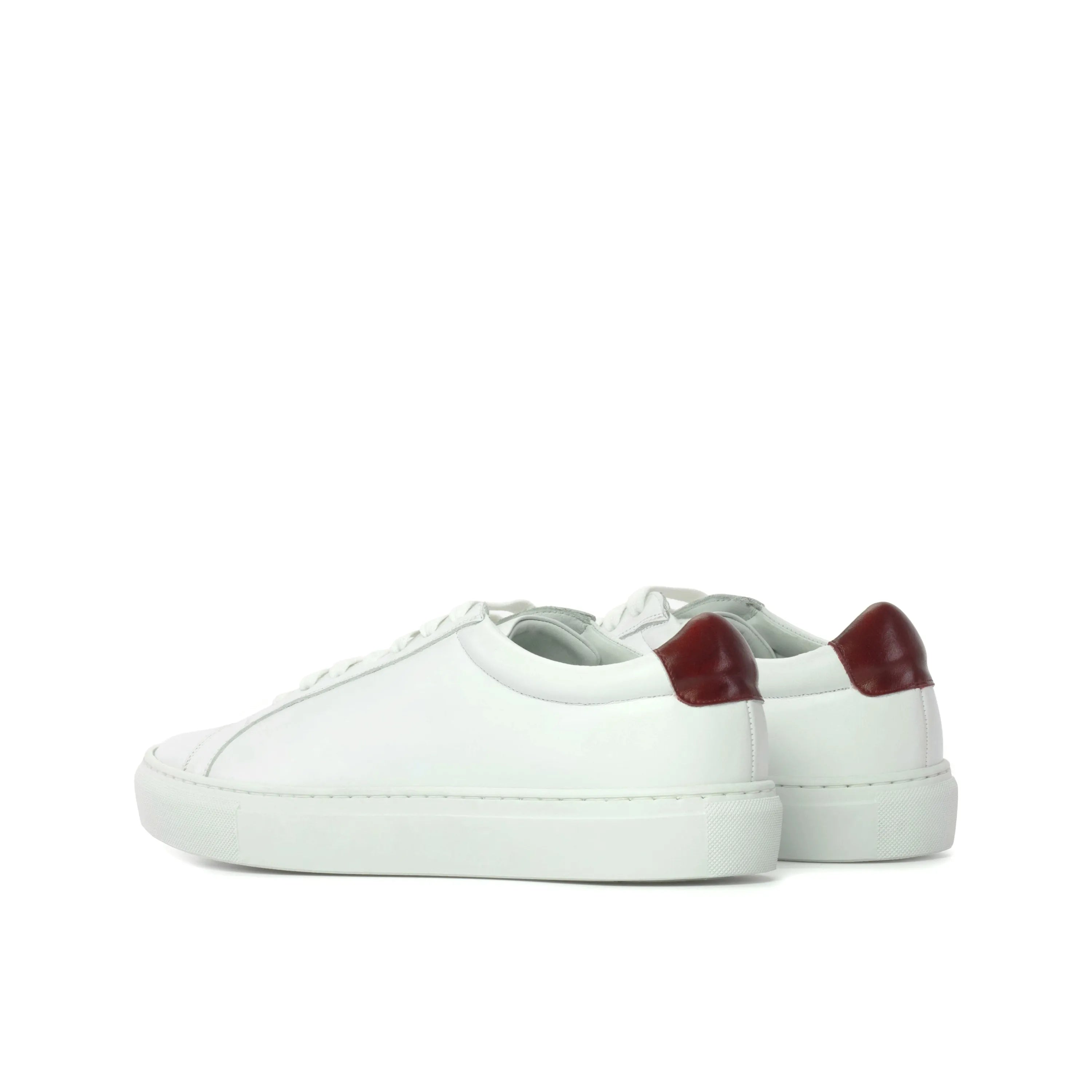White leather Sima Low Kick Sneakers featuring a stylish burgundy heel detail