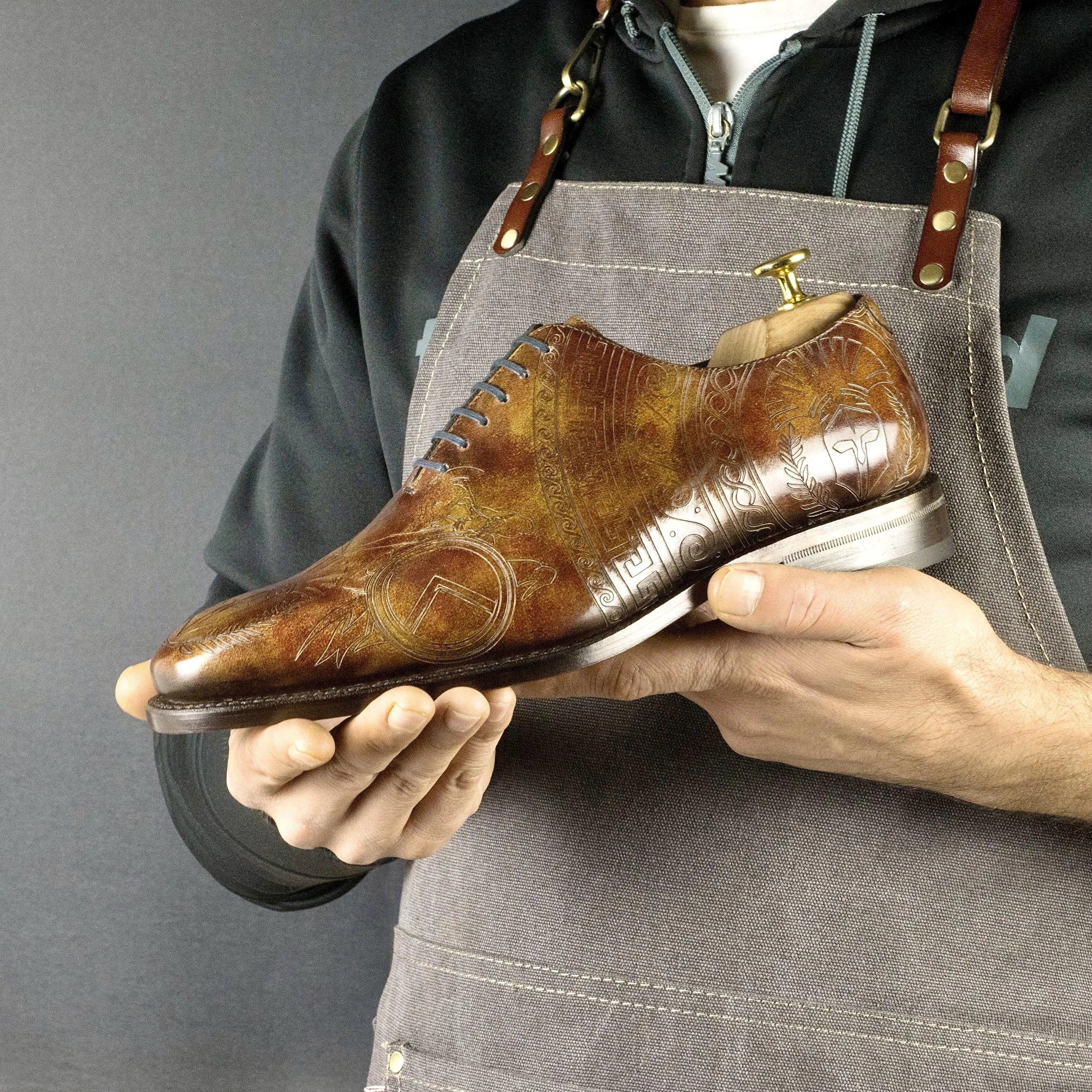 Brown leather Sparta Patina Wholecut shoe featuring elegant decorative etchings