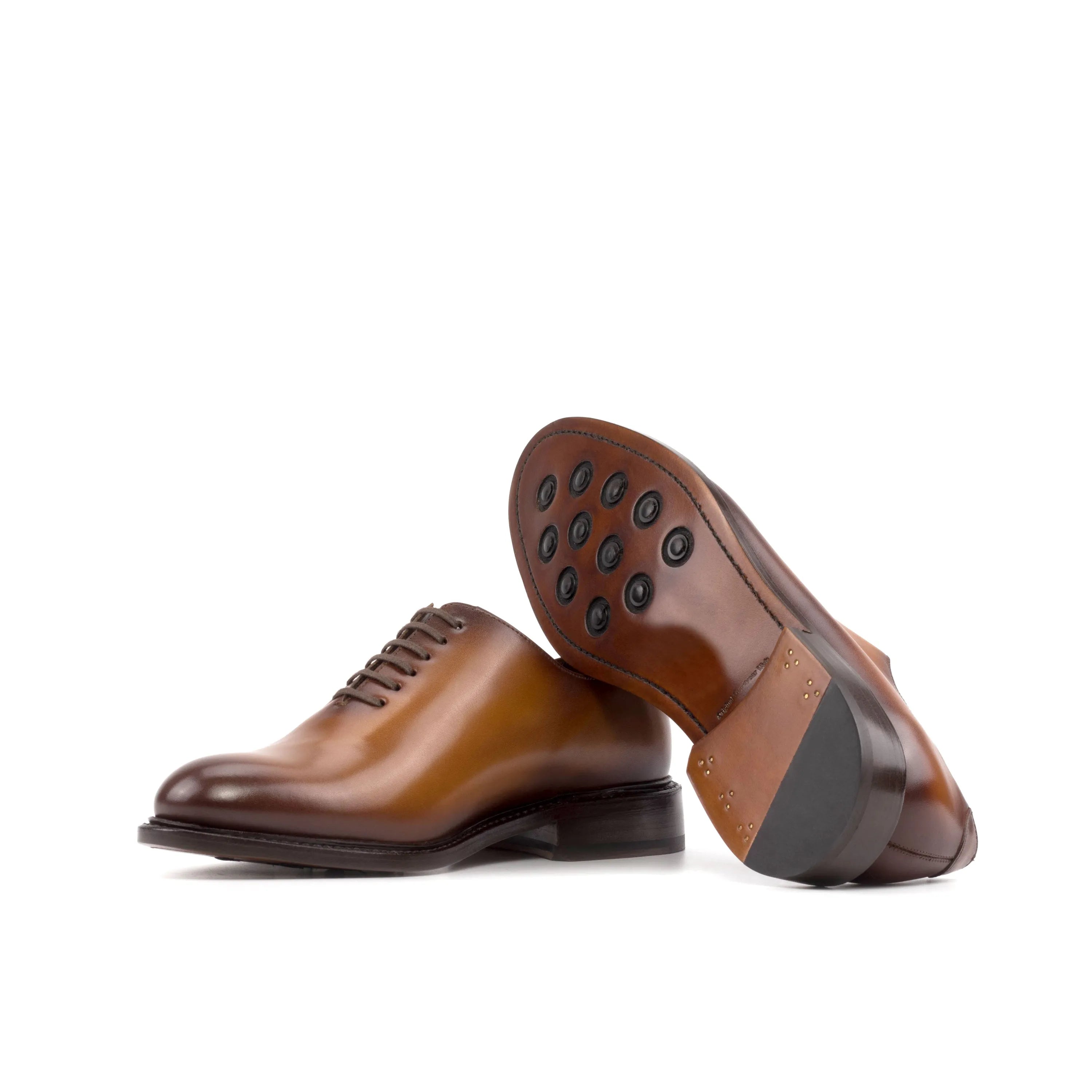 Pair of brown leather Stellar Wholecut shoes showcasing elegant craftsmanship