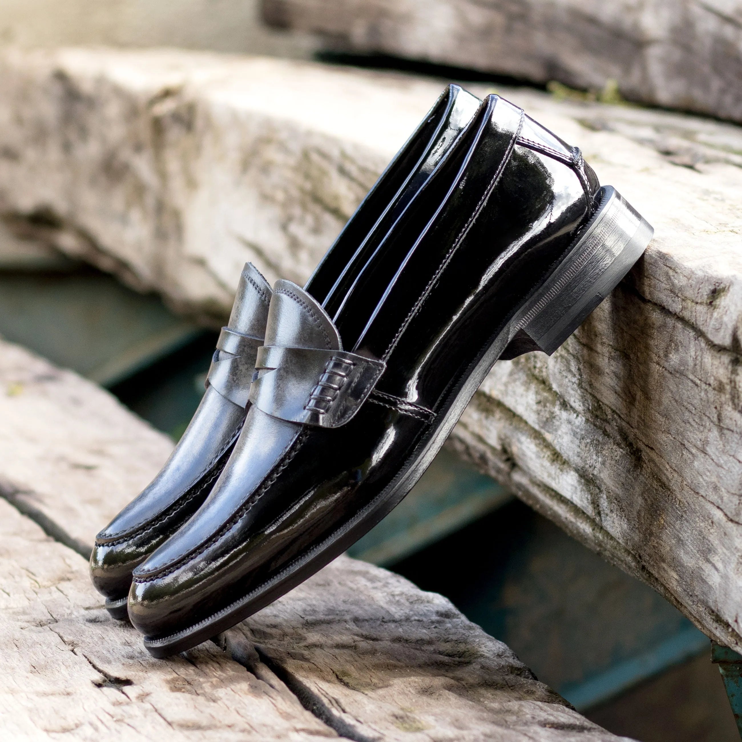 Shiny black Titani Unisex Patina Loafers showcasing elegant design and versatile style