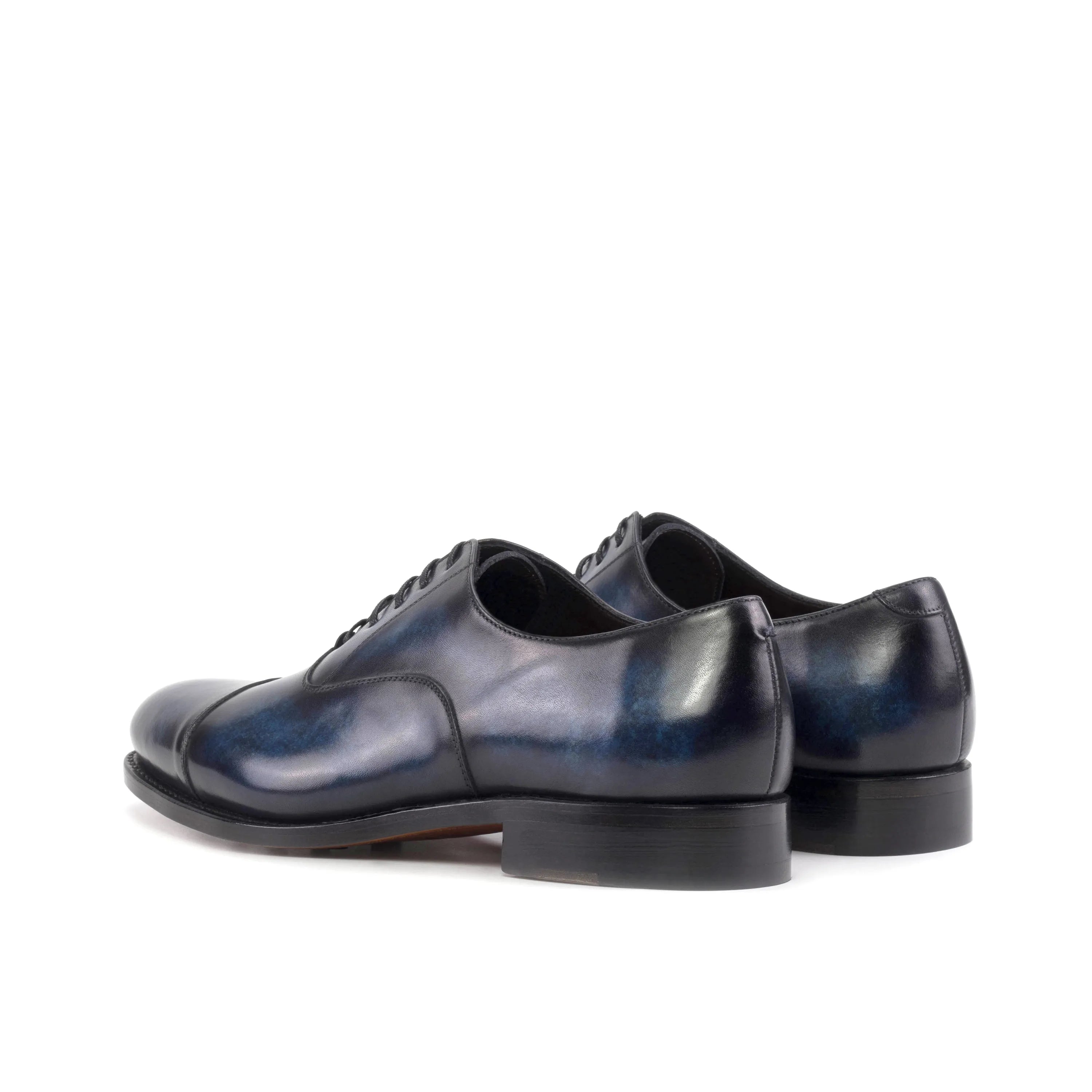 Pair of blue leather Vanguard Patina Oxford shoes elegantly displayed for purchase
