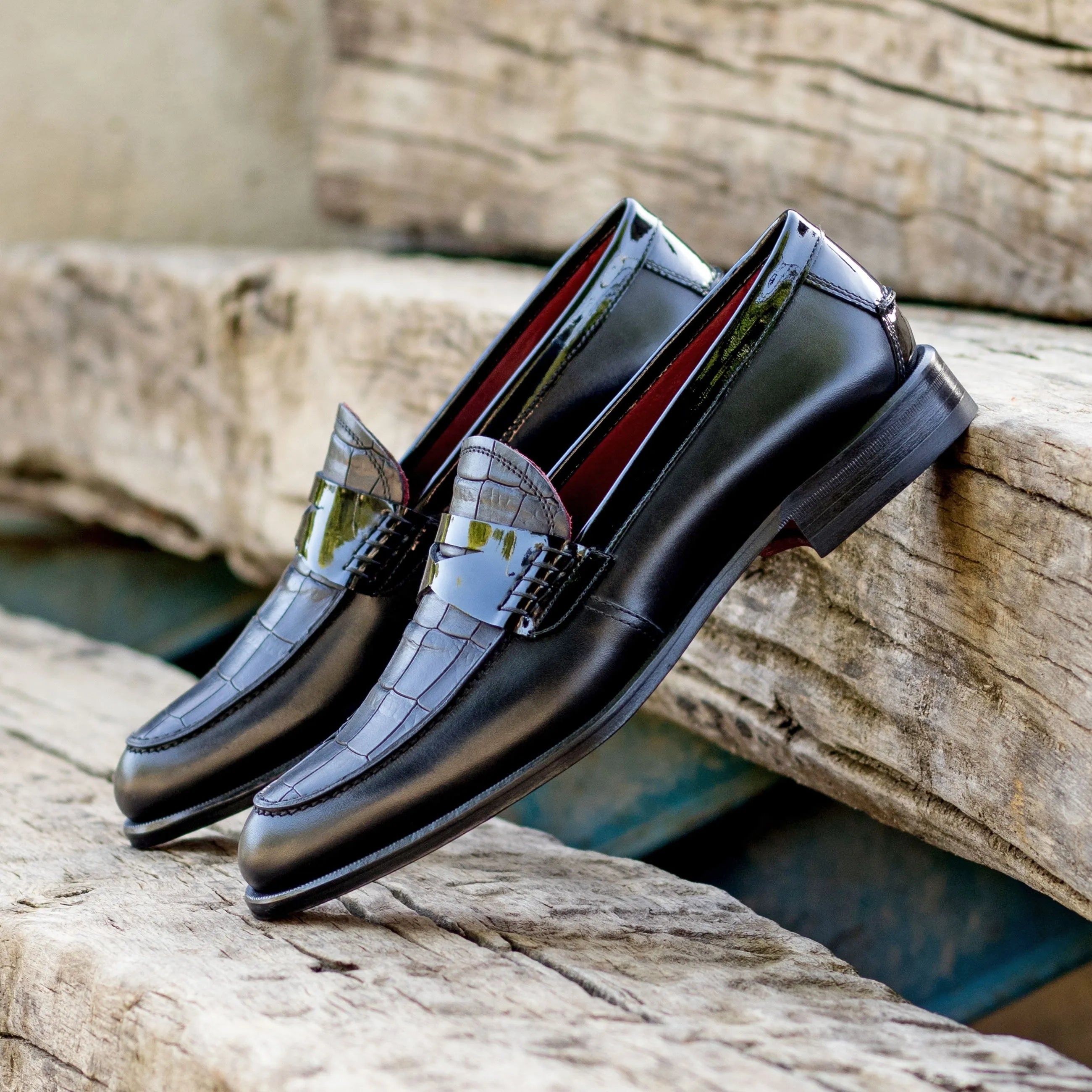 Pair of black leather XO unisex loafers elegantly displayed with a luxury bespoke look