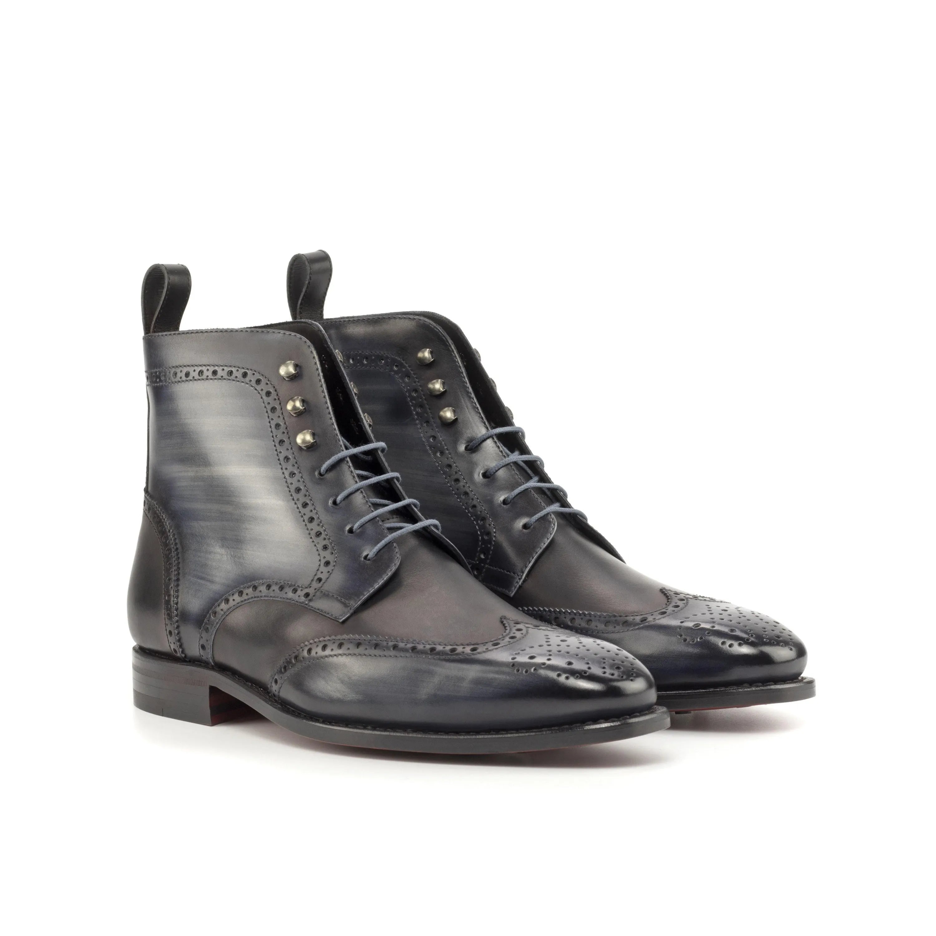 Pair of gray leather Zdan Military Brogue Patina Boots II showcasing elegant brogue design