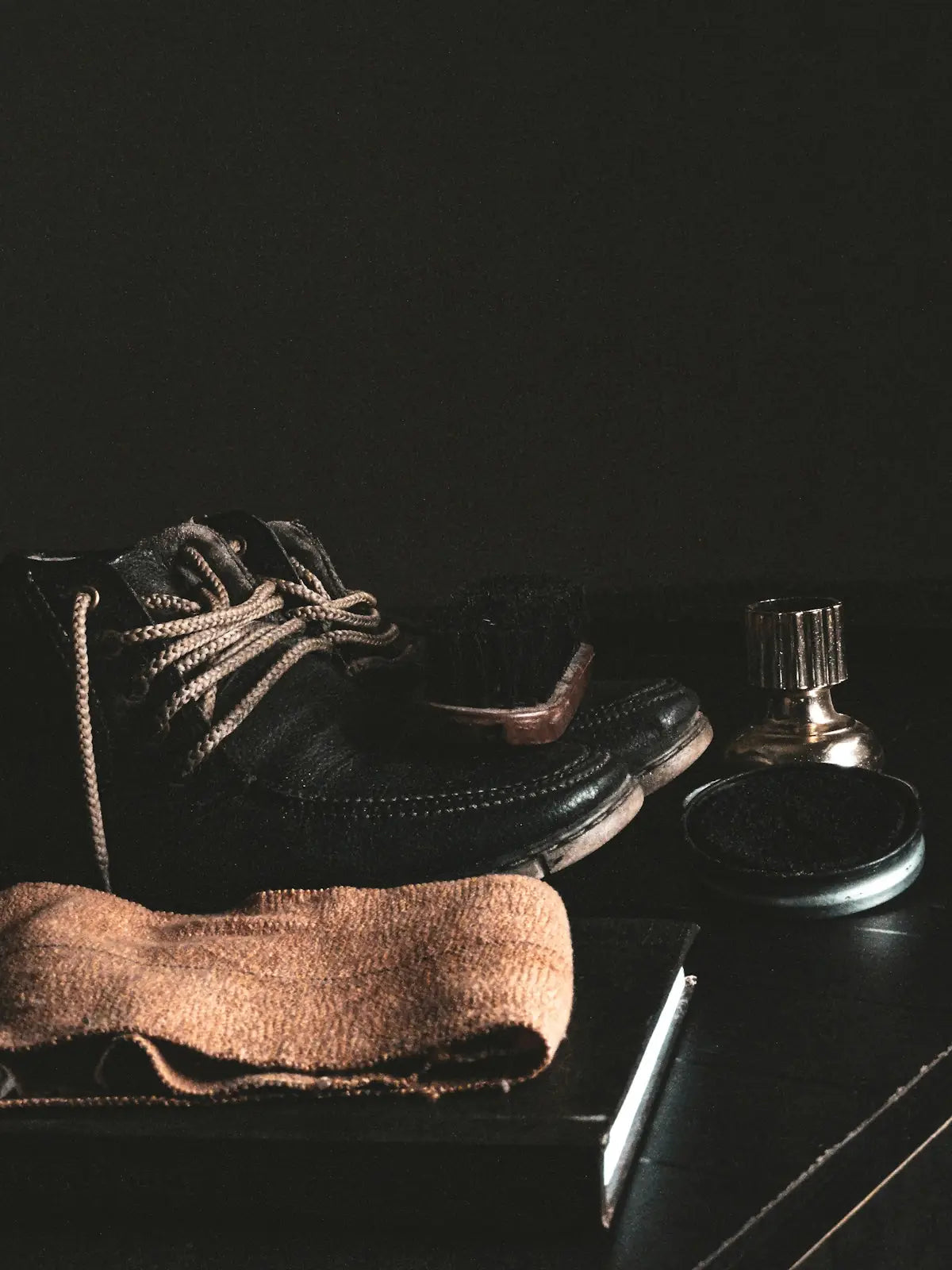 person wearing brown sock and black leather boots