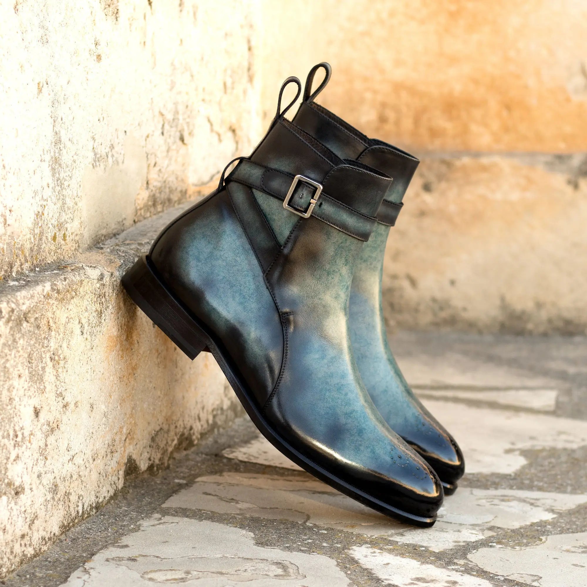 Blue leather ankle boots with buckle strap.
