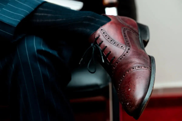 person wearing brown leather shoe