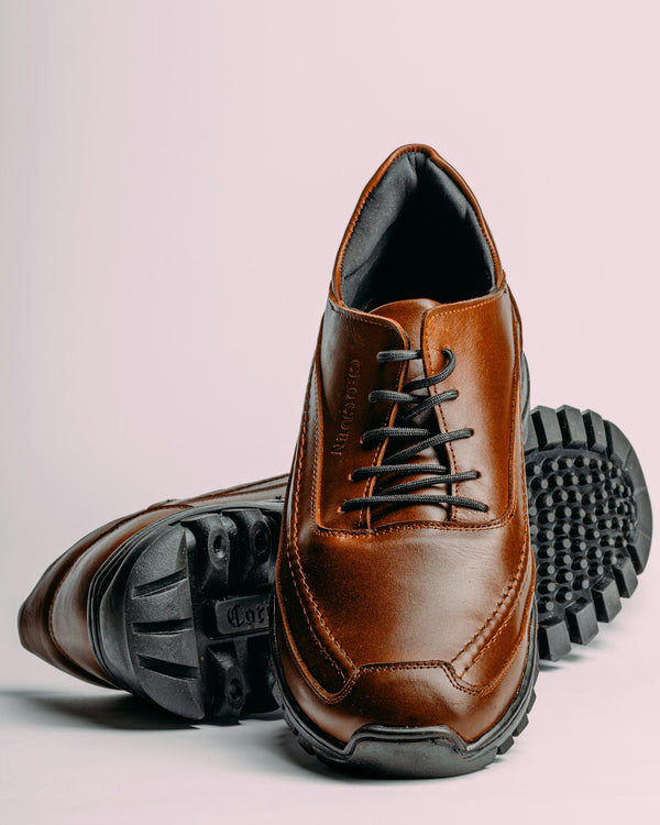 a pair of brown shoes with black soles