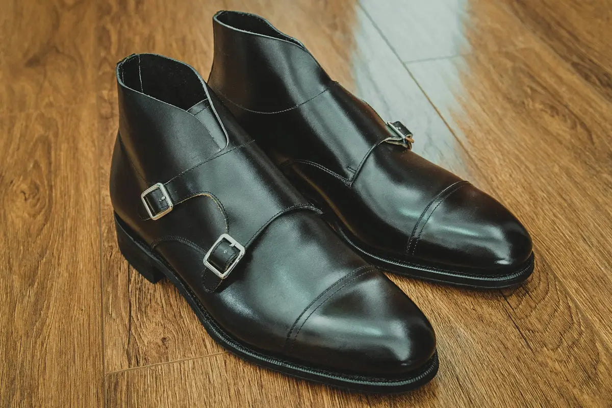 black leather shoes on brown wooden floor