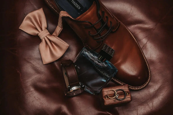 A pair of brown shoes and a brown bow tie