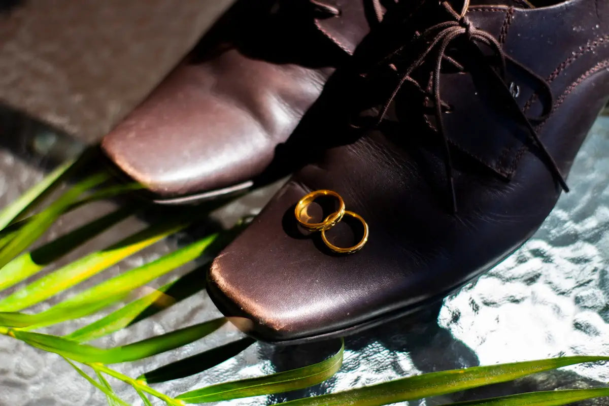 black leather bag on green and white leaf plant