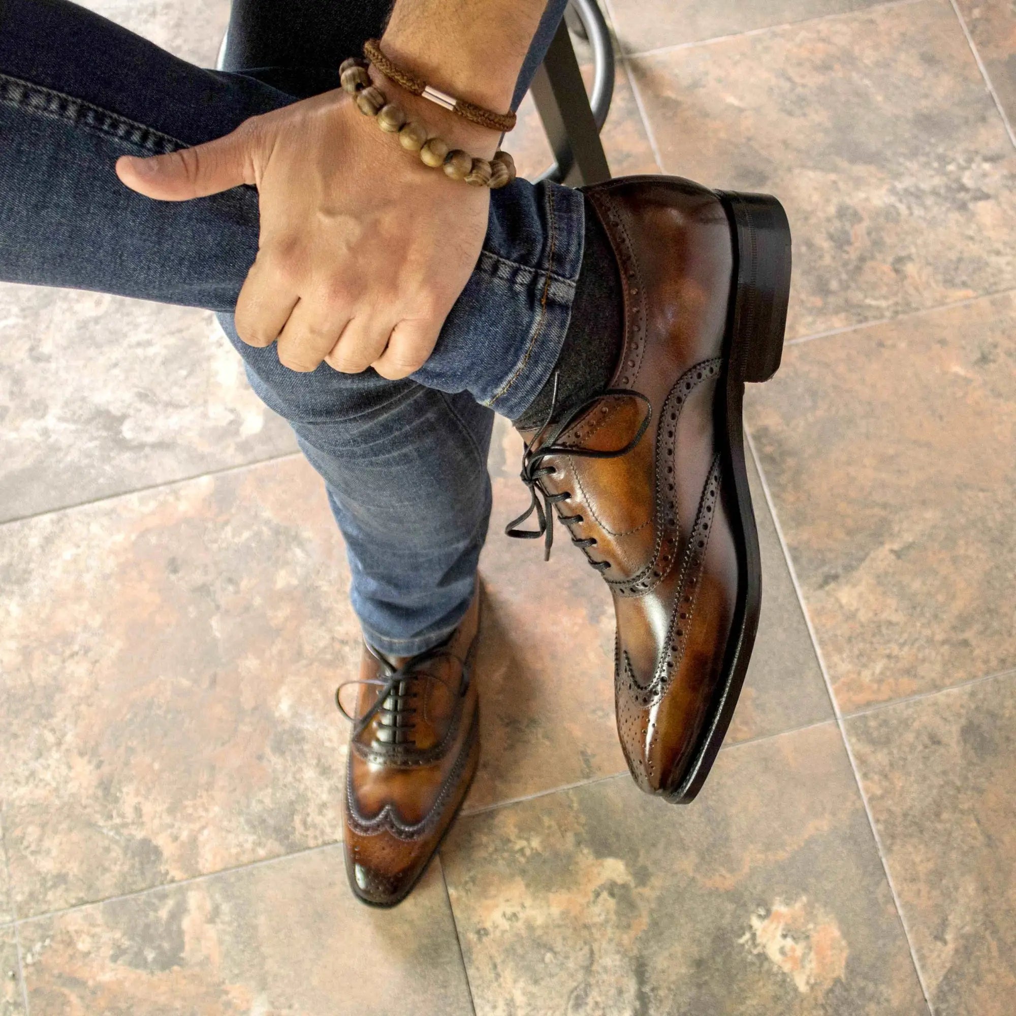 Brown leather wingtip dress shoes.