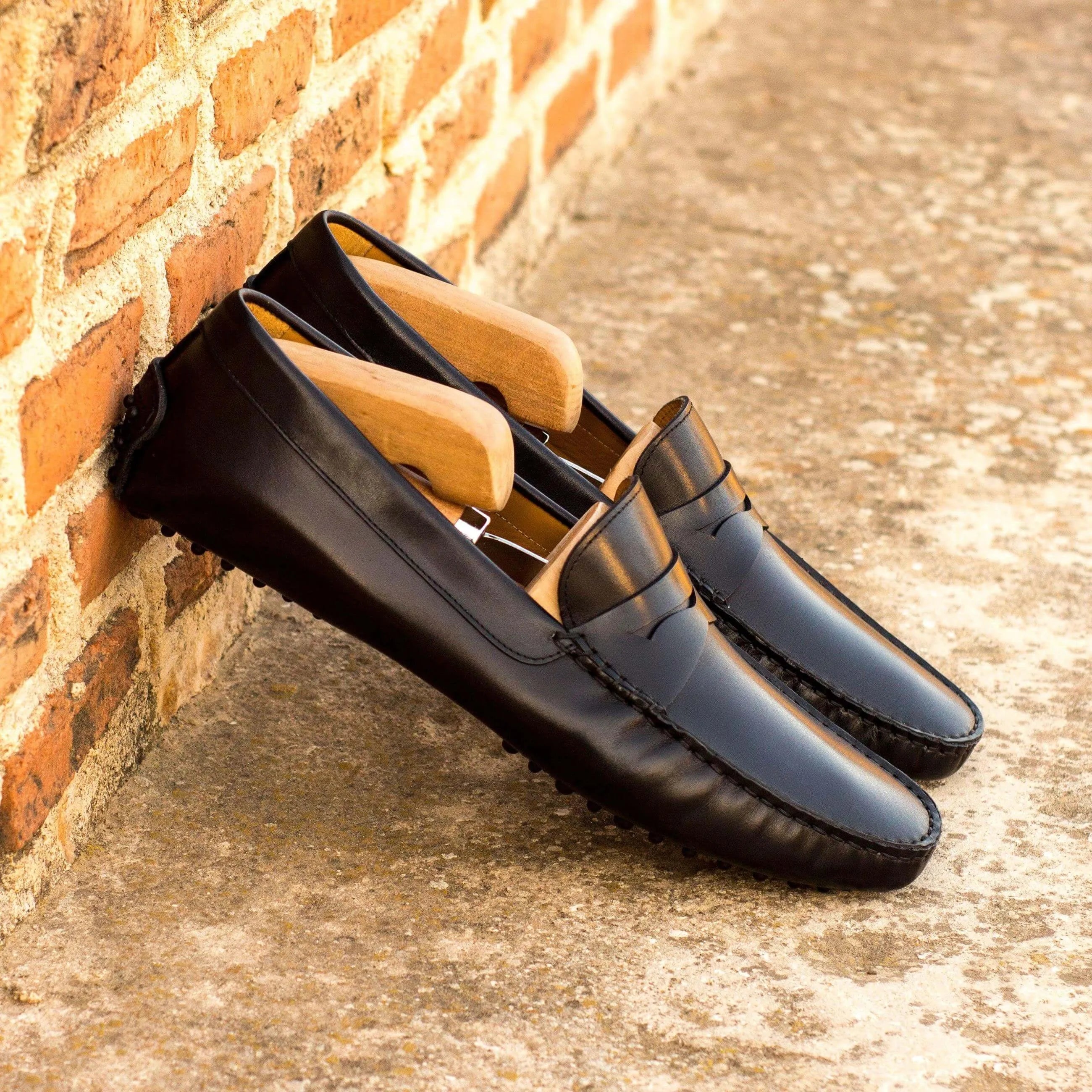 Black leather loafers with shoe trees, ideal for driving, featured in the 1963 Driver collection
