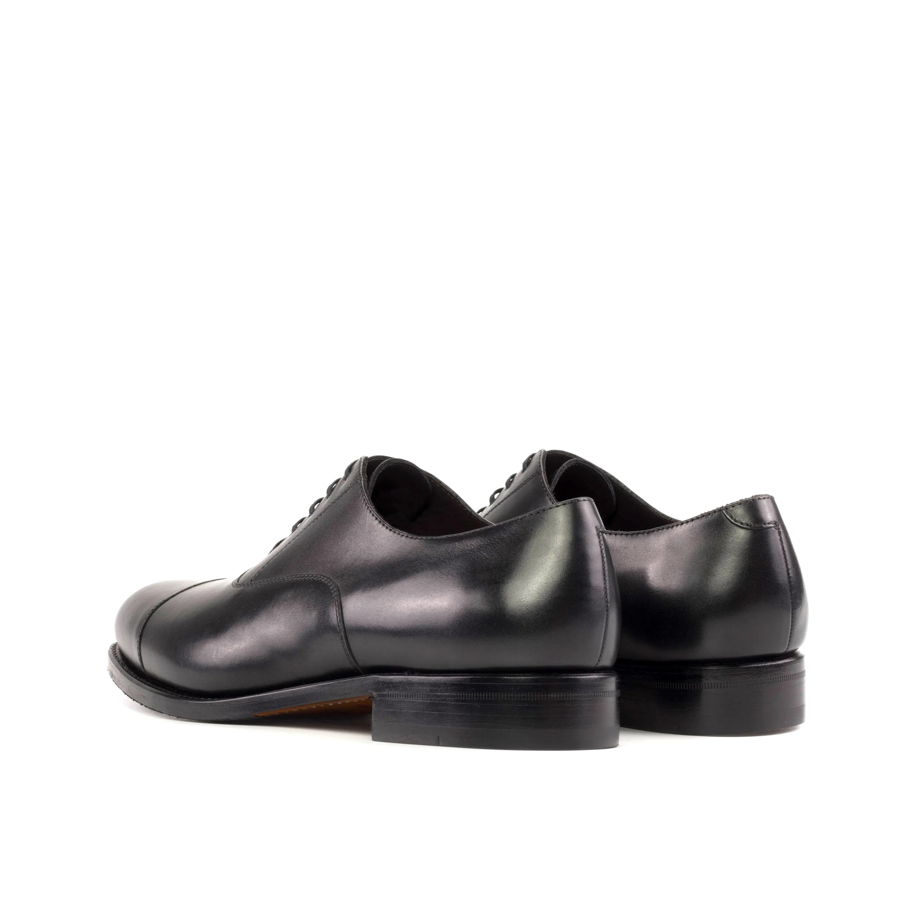 Pair of luxury black leather Oxford shoes for men, ideal for custom suits and shoes for executives