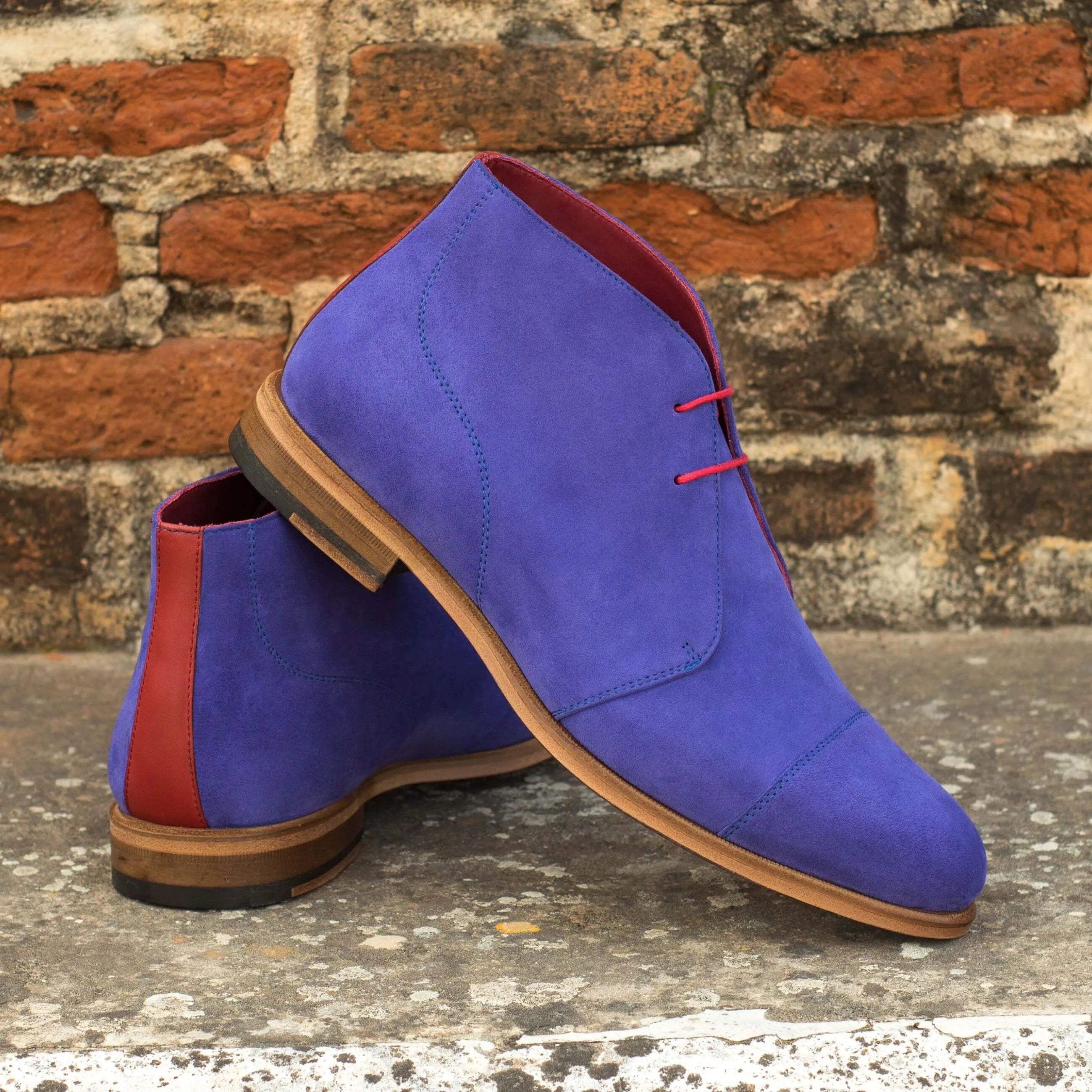 Blue suede Admiral Chukka boots featuring a stylish design and elegant patina finish