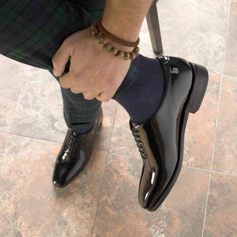 Shiny black Agent2 Wholecut shoes II showcasing elegant wholecut design and craftsmanship
