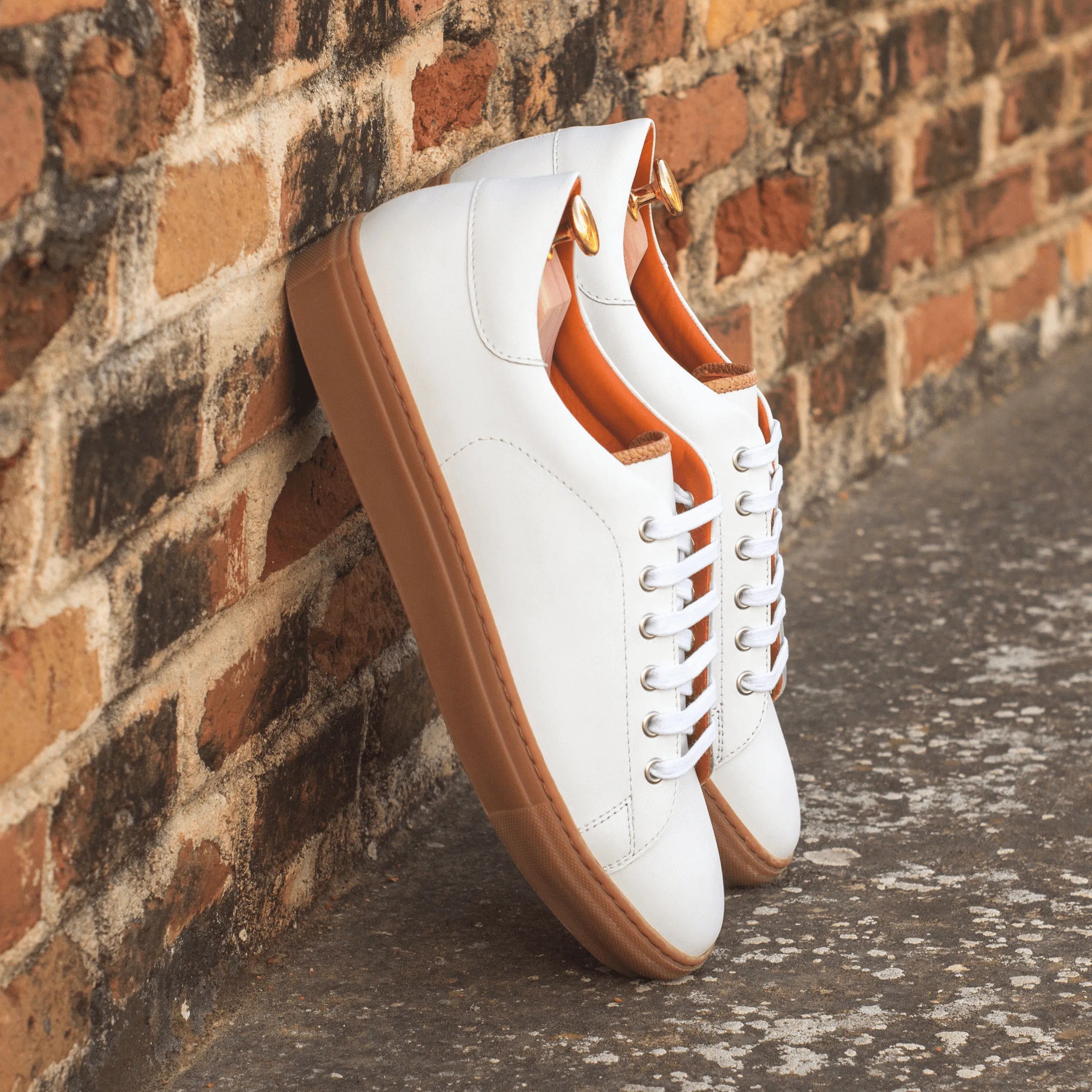 White leather Alon Trainer Sneaker with brown soles, showcasing a stylish cupsole trainer design
