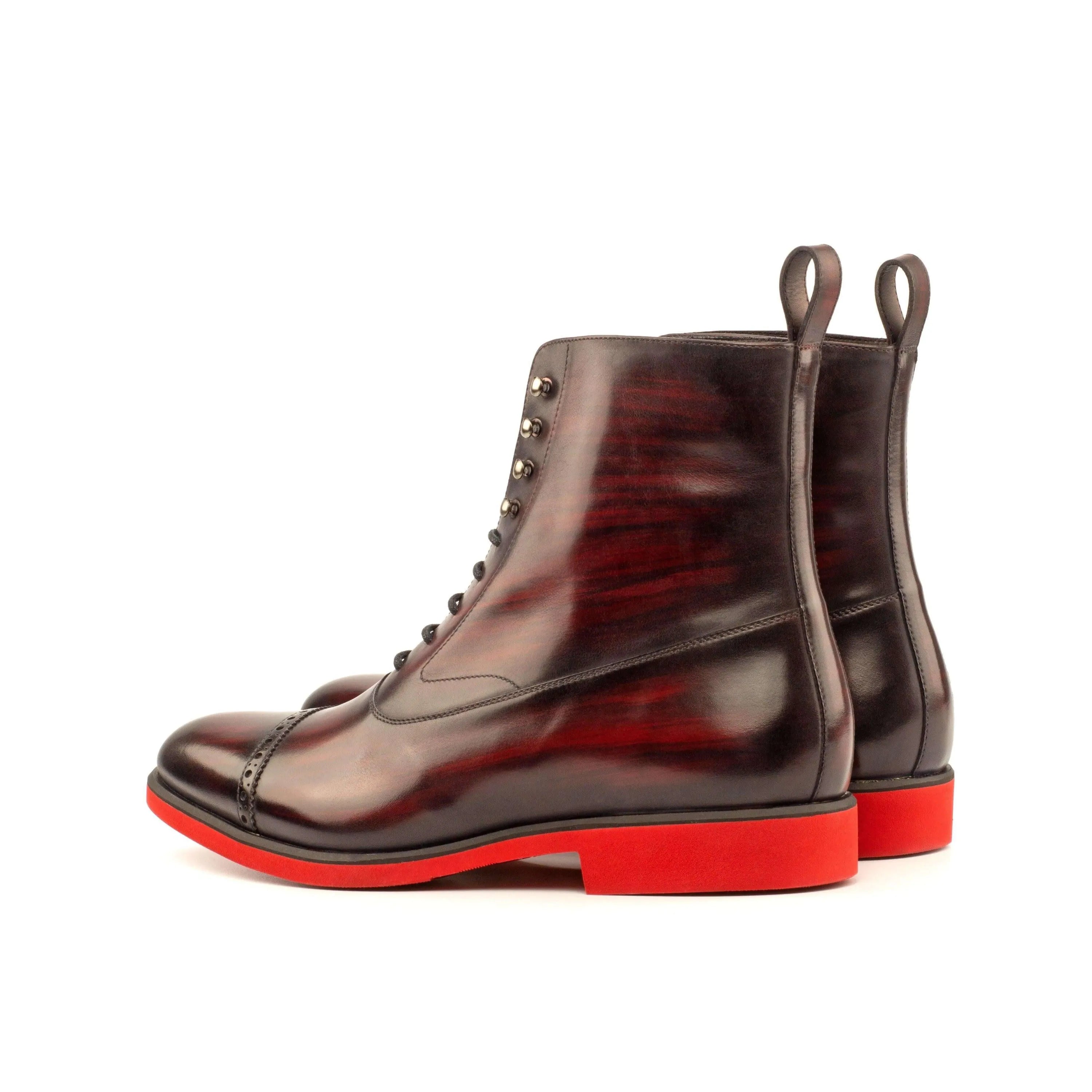 B61 Balmoral Patina Boots II featuring burgundy leather with striking red soles