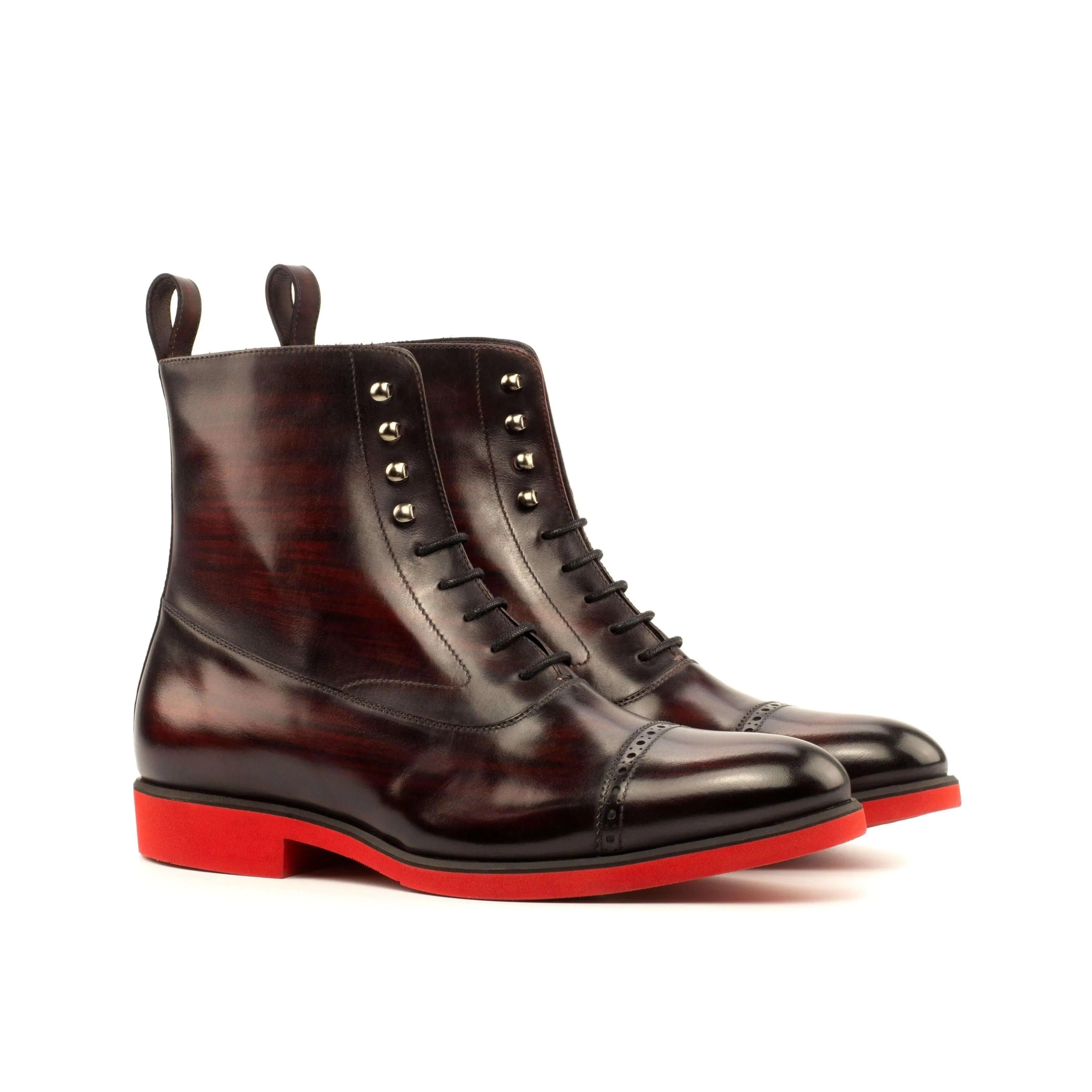B61 Balmoral Patina Boots II featuring burgundy leather and striking red soles