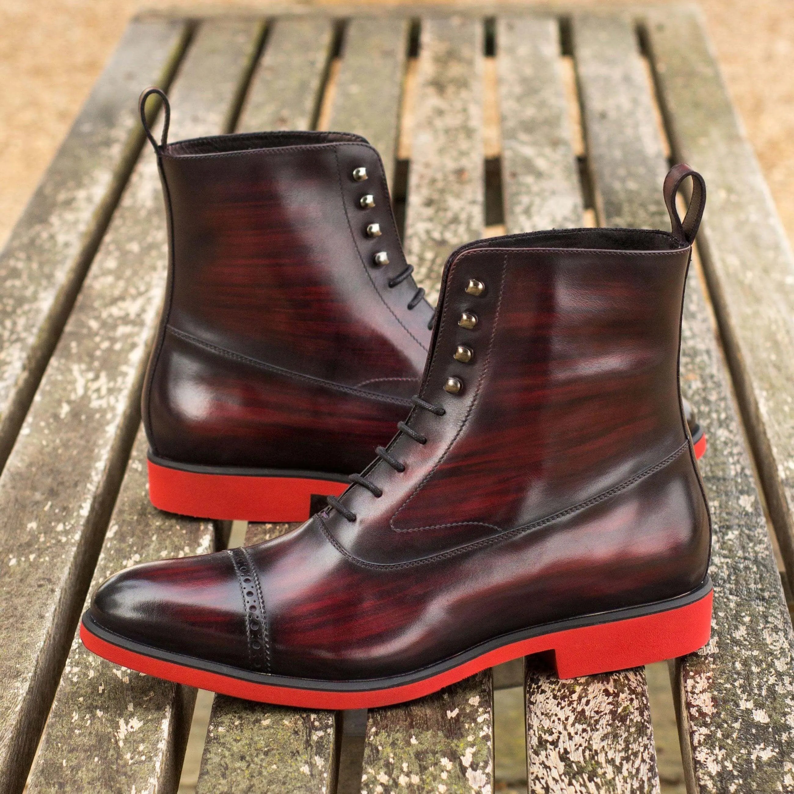 B61 Balmoral Patina Boots II featuring burgundy leather and red soles for elegant style