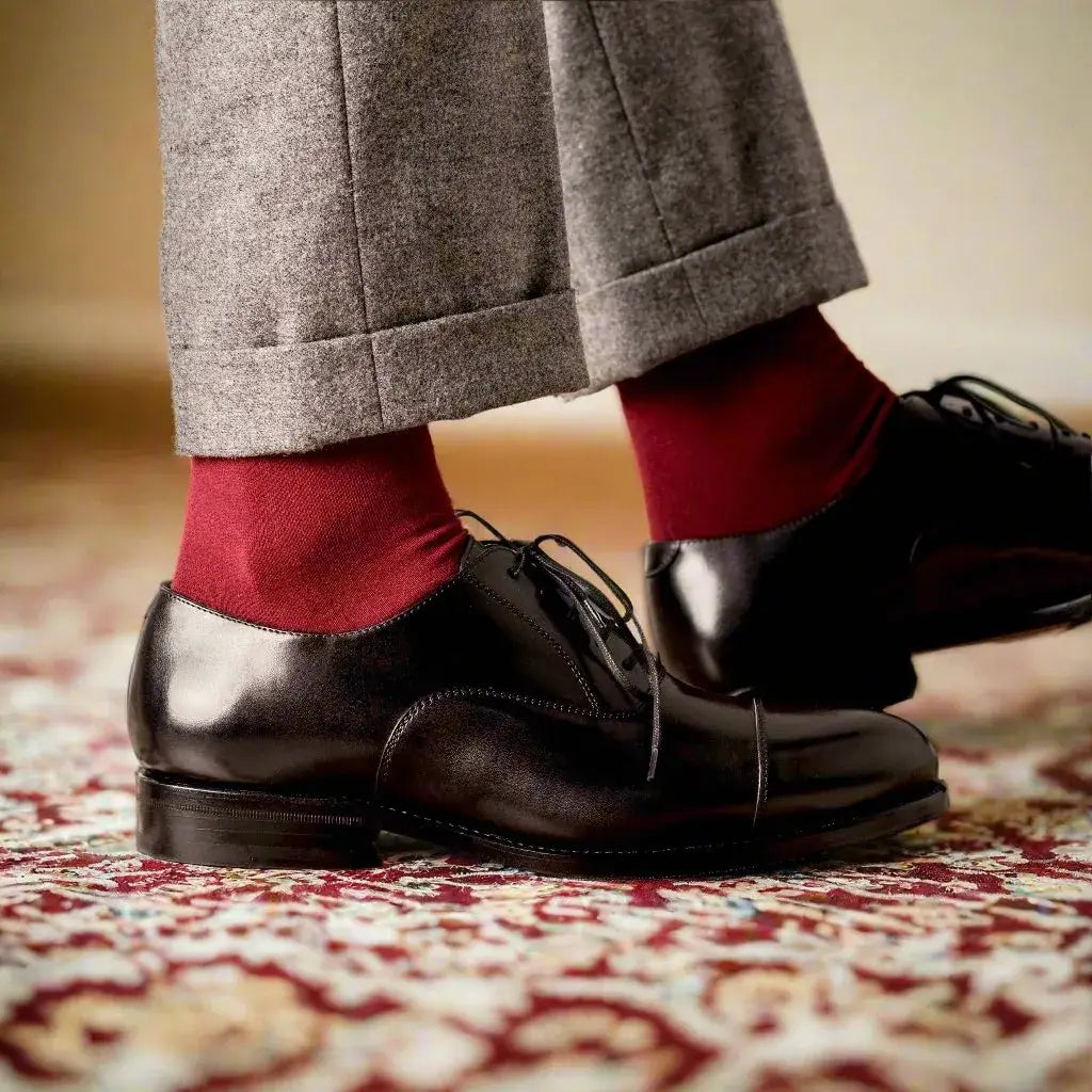 Polished black leather cap-toe oxfords in luxury footwear chronicles