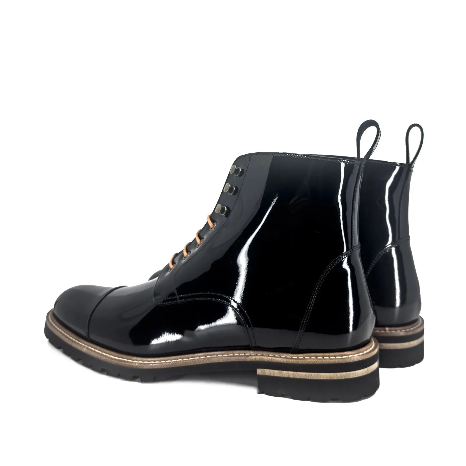 Pair of shiny black leather Bossy unisex Captoe Boots for versatile style and comfort