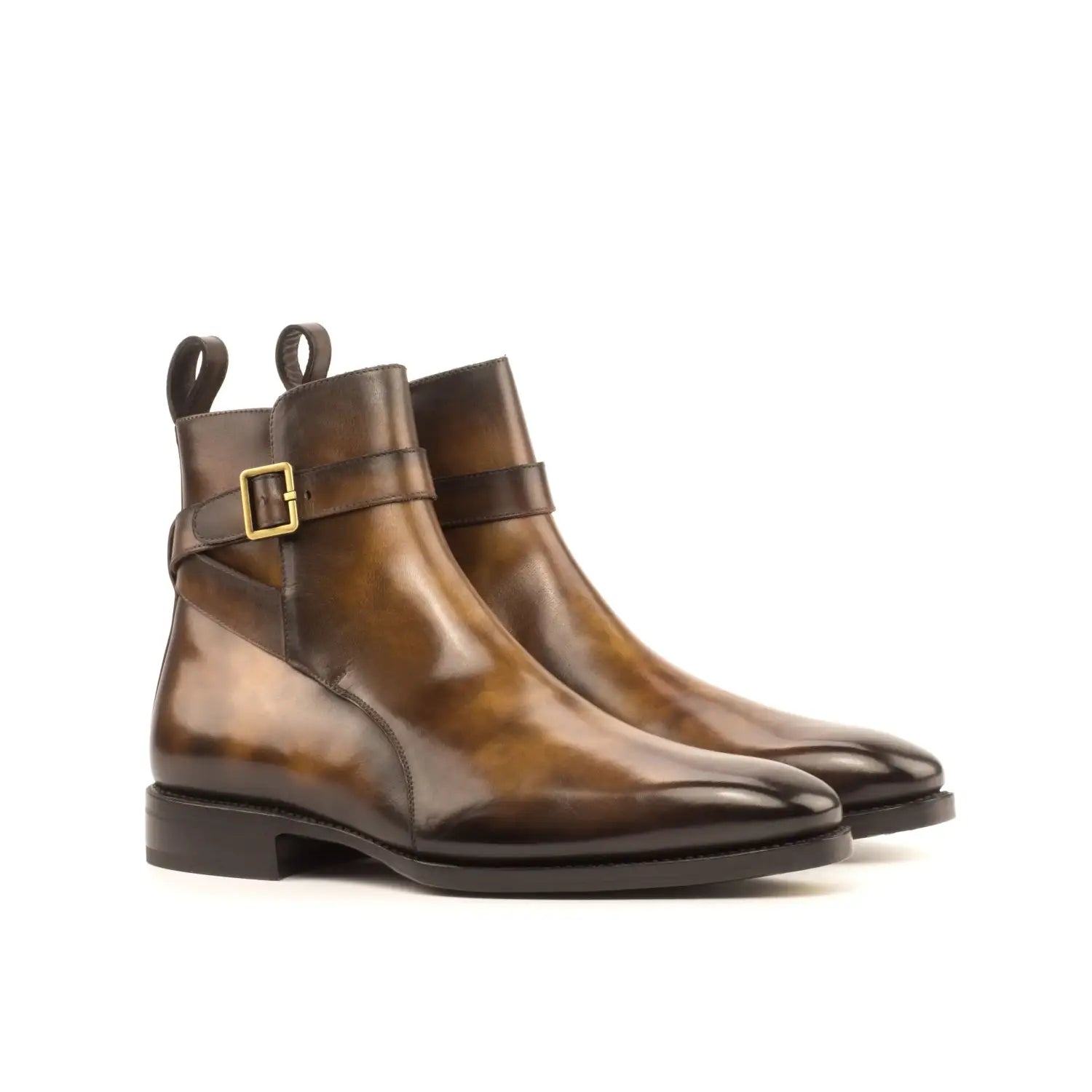 Brown leather Chelsea boots with gold buckle in luxury footwear chronicles