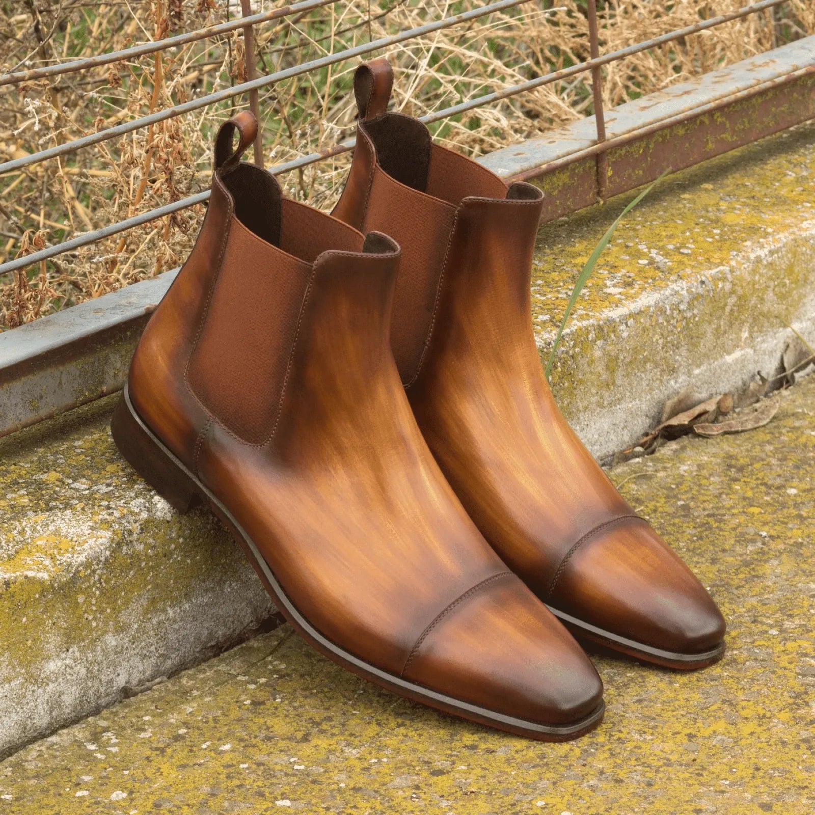 Pair of brown leather Caratacos Patina Chelsea boots showcasing premium craftsmanship