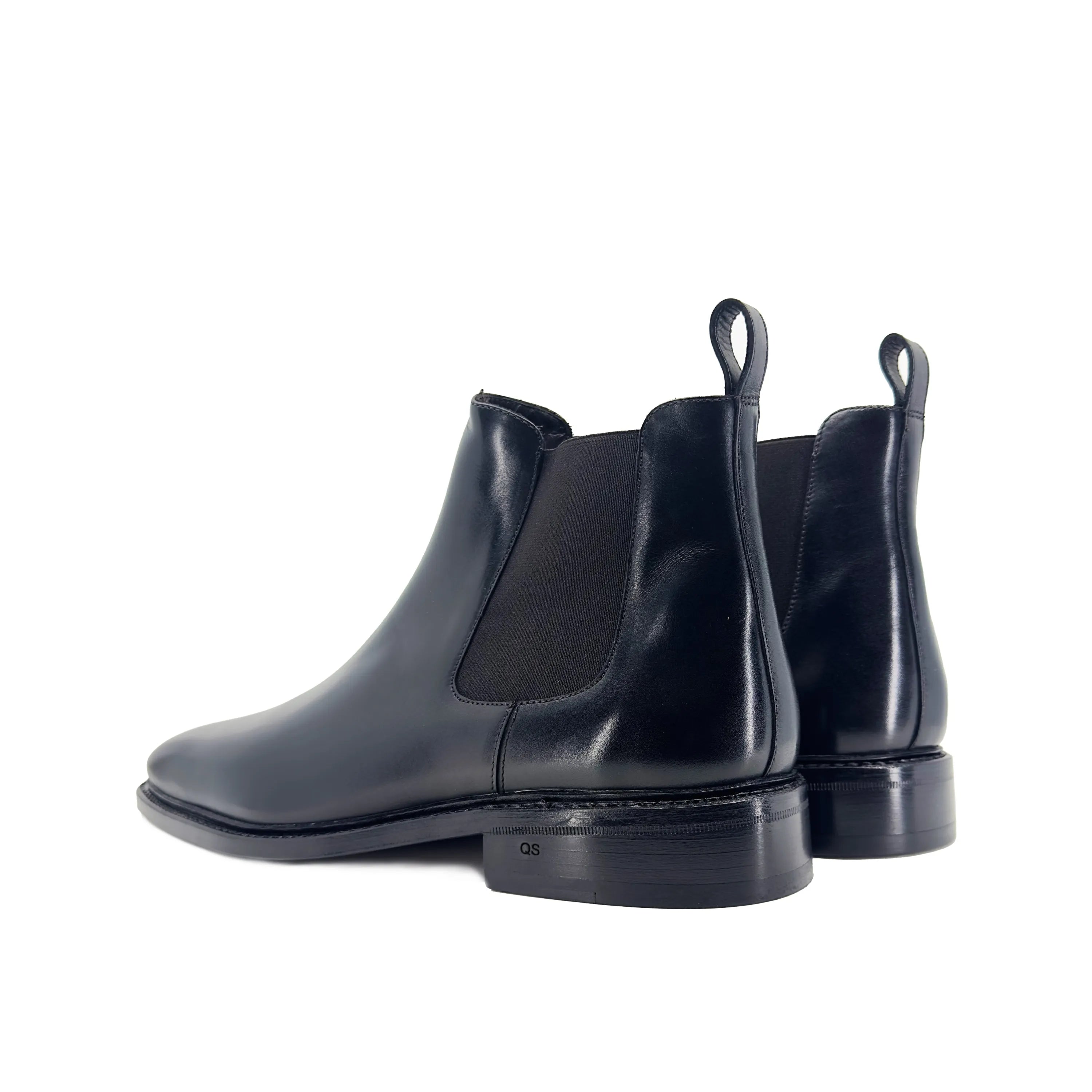 Pair of black leather Cave Chelsea Boots showcasing stylish and versatile footwear
