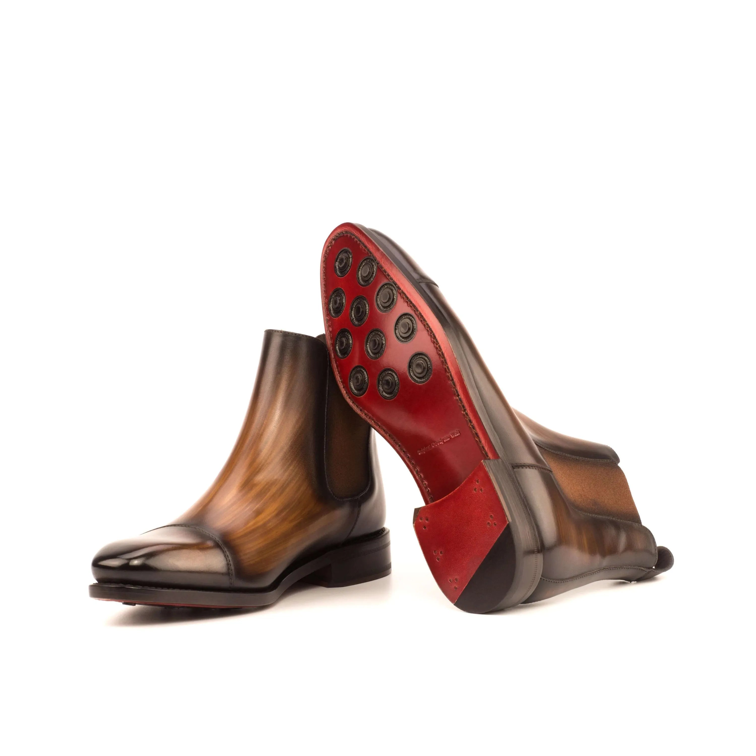 Brown leather Chayton Patina Chelsea boots featuring distinctive red soles