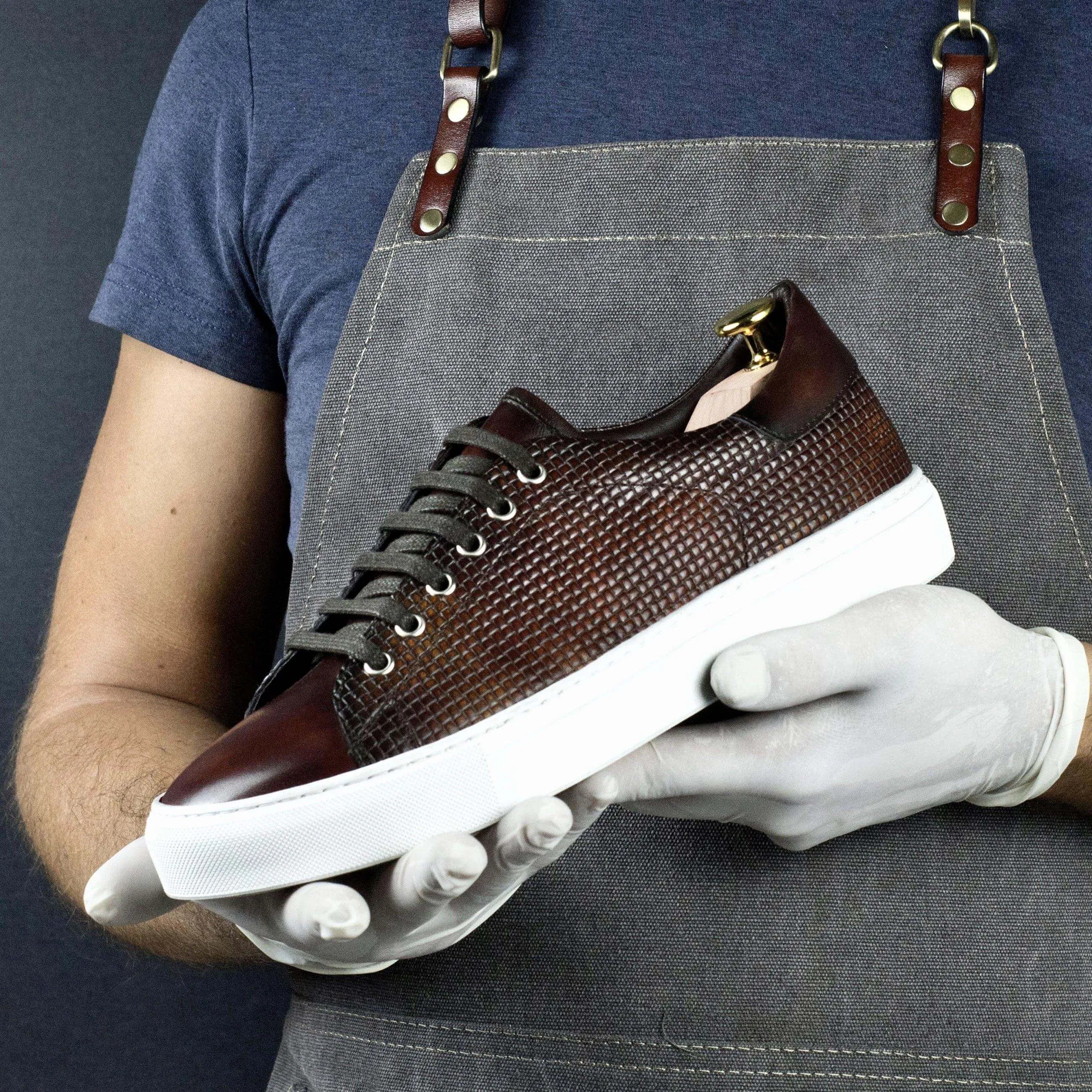 Brown leather Copa Braided Patina sneaker featuring a white sole for stylish comfort