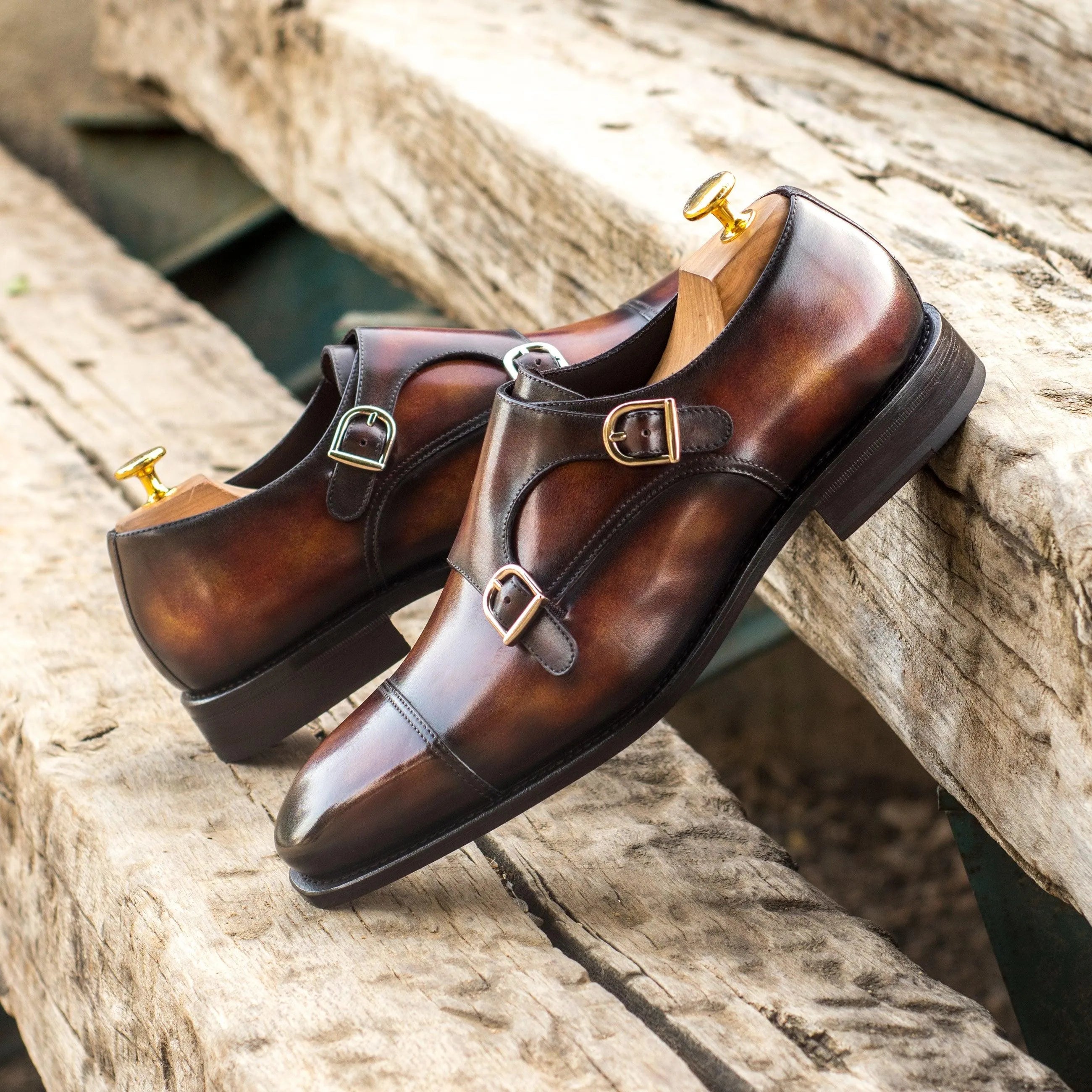 Pair of brown leather double monk patina shoes with chisel toe design from Deen