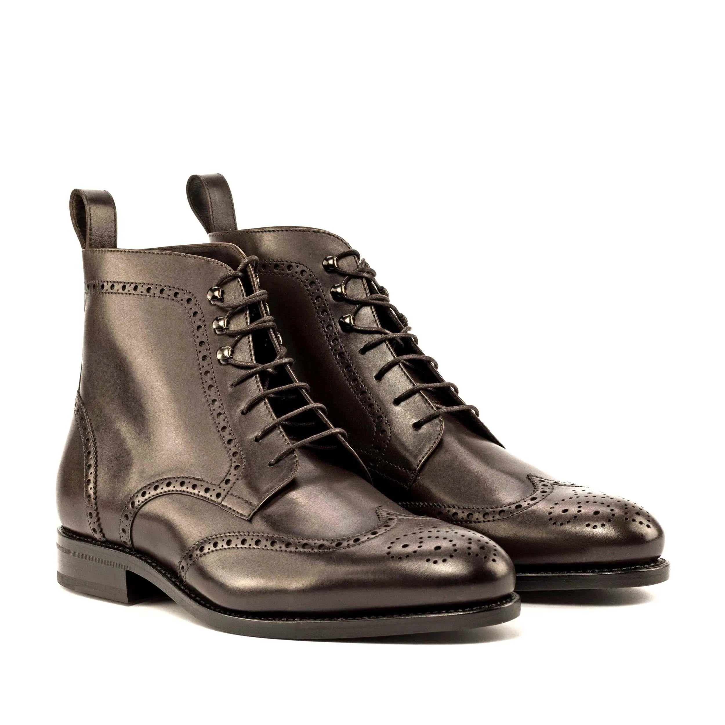 Brown leather wingtip boots, featuring the Devin Military Brogue design
