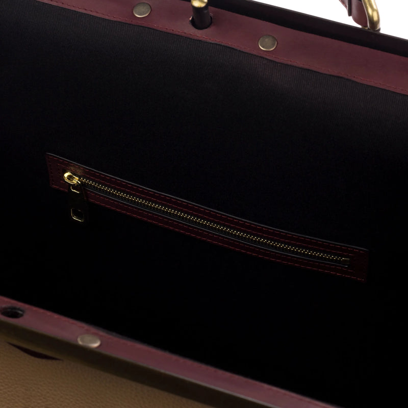 Open burgundy leather Doc 2 Bag showcasing unique savoir-faire and elegant style