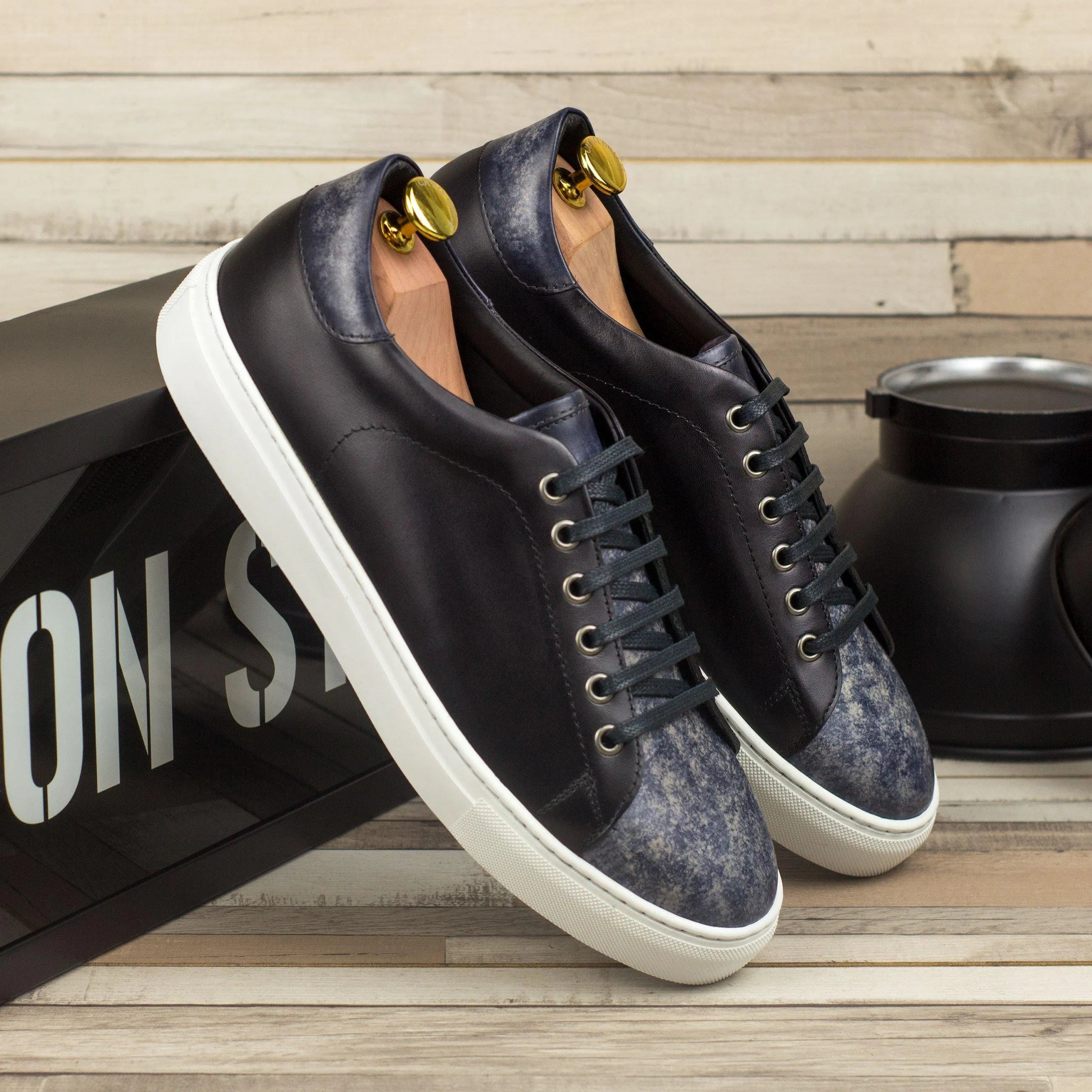 Pair of black leather DTT3 Trainer Patina Sneakers displayed on a neutral background