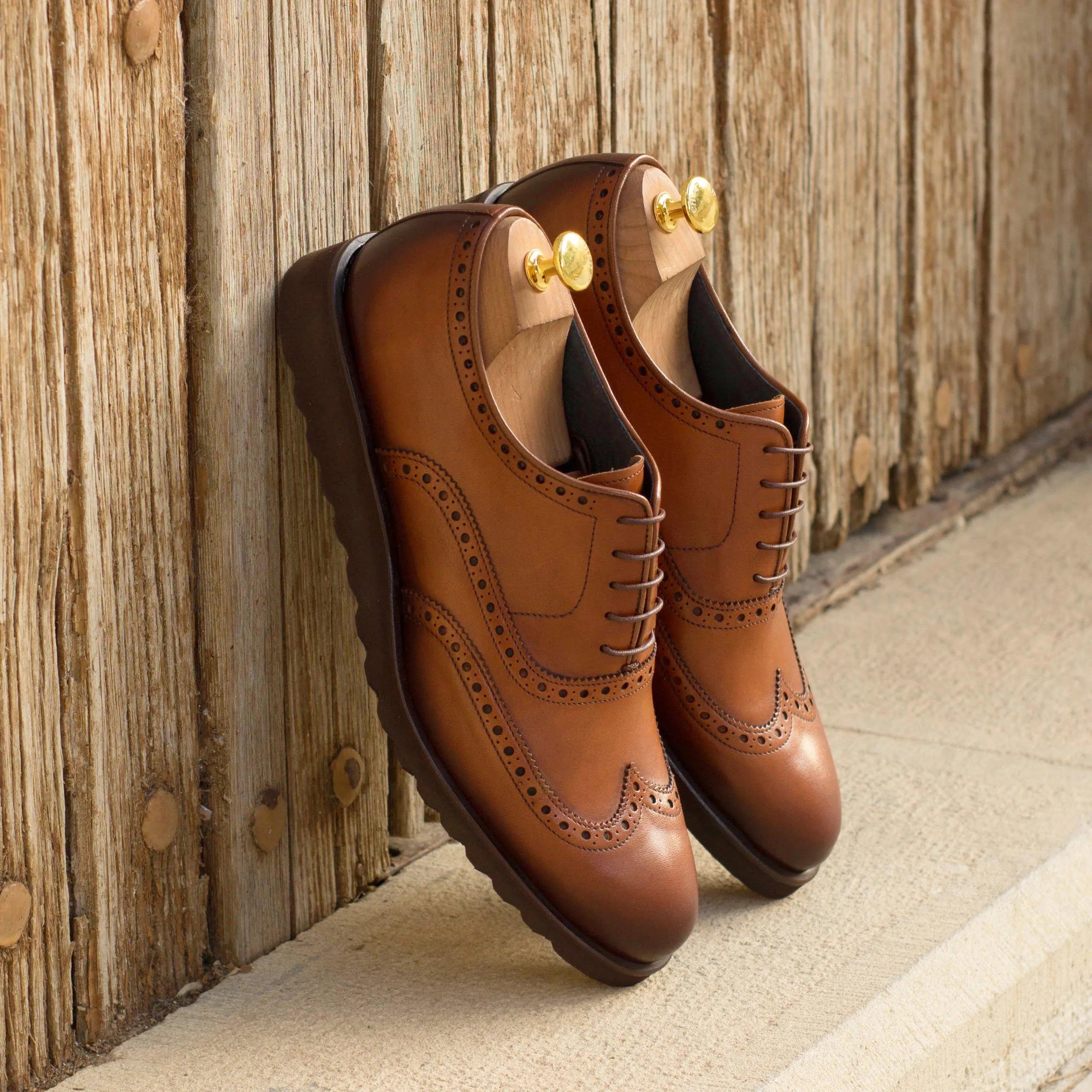 Pair of brown leather wingtip dress shoes in Dyami Full Brogue II with rounded toe design