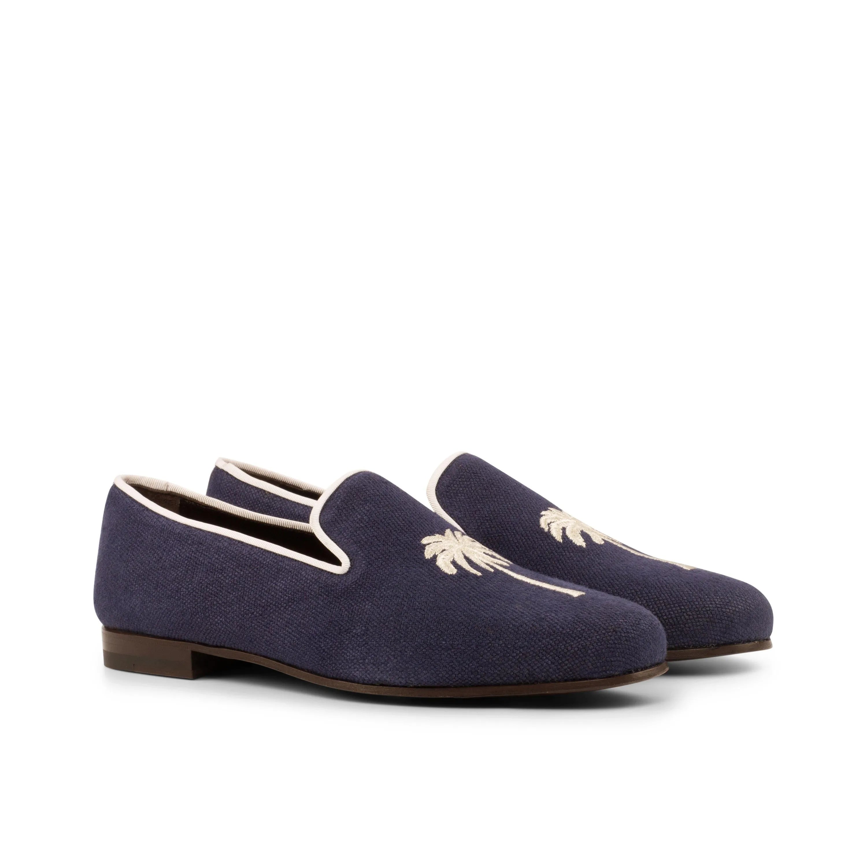Navy blue palm tree loafers from the Eagle Wellington slip collection showcased elegantly